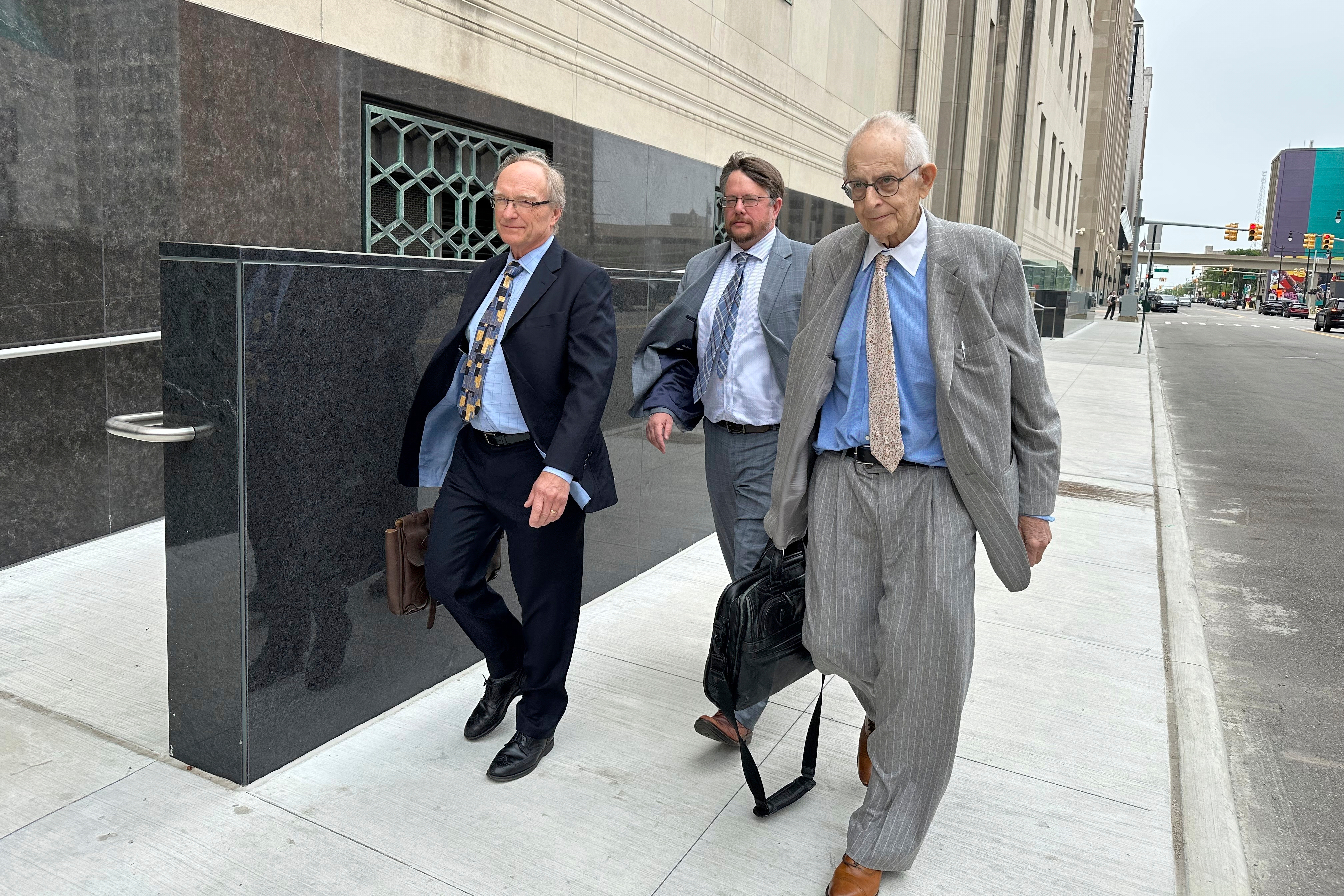 Defense lawyers for Chinese scientist Yunqing Jian, from left, David Duncan, James Gerometta and Norman Zalkind leave federal court in Detroit on June 13, 2025. (AP Photo/Ed White)