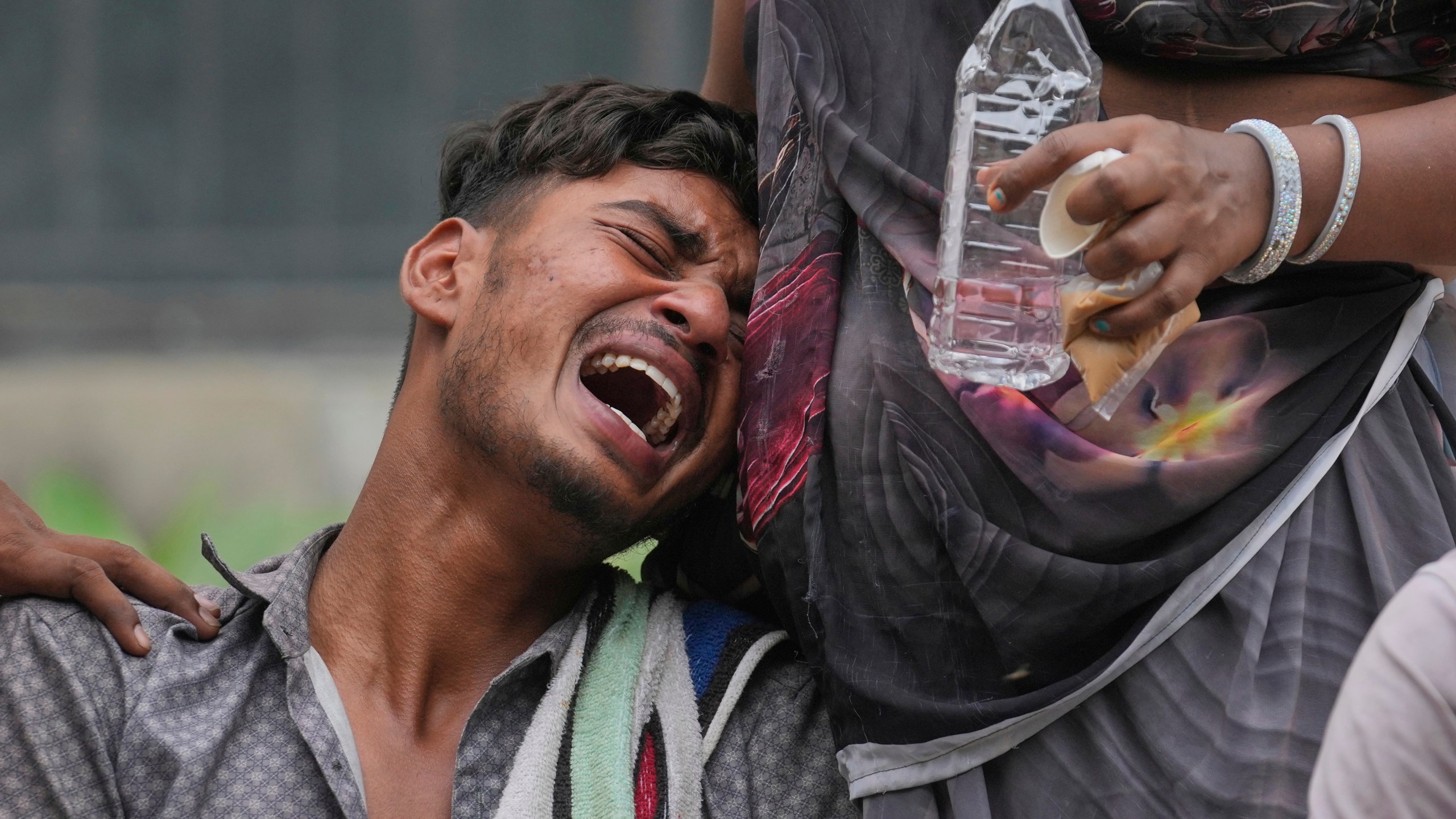Kalpeshbhai Patni, whose 14-year-old brother was killed when an Air India plane crashed into a neighborhood, wails outside the autopsy room at a hospital in Ahmedabad, India, Friday, June 13, 2025. (AP Photo/Rafiq Maqbool)