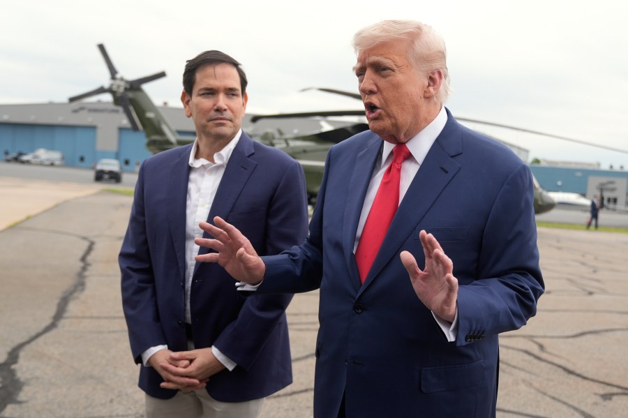 President Donald Trump, right, speaks with reporters as Secretary of State Marco Rubio listens upon arriving at Morristown Municipal Airport in Morristown, N.J., en route to Camp David, Md., Sunday, June 8, 2025. (AP Photo/Manuel Balce Ceneta)