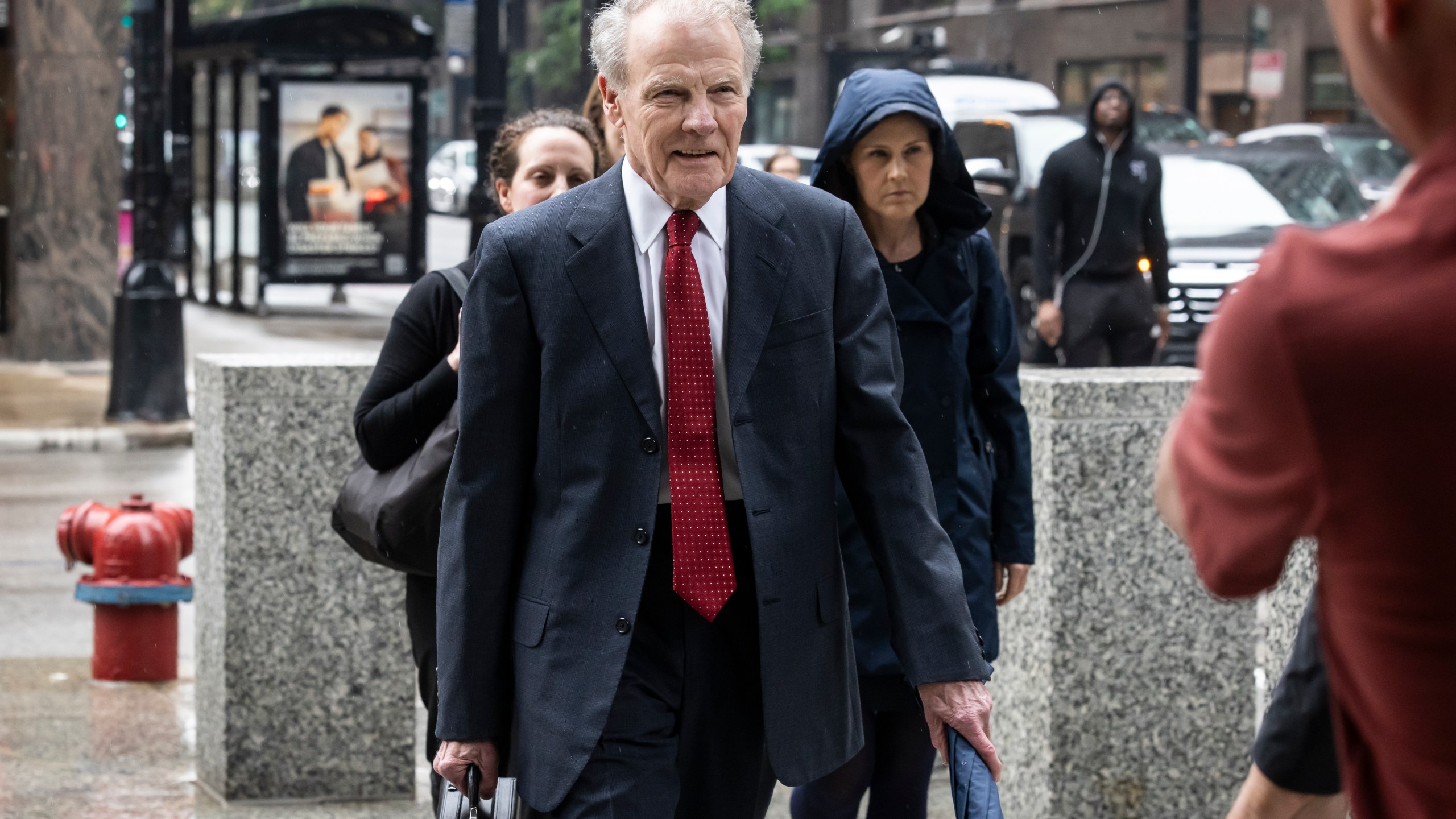 Flanked by attorneys and supporters, Illinois' former House Speaker Michael Madigan walks into the Dirksen Federal Courthouse for his sentencing hearing, Friday, June 13, 2025, in Chicago. (Ashlee Rezin/Chicago Sun-Times via AP)