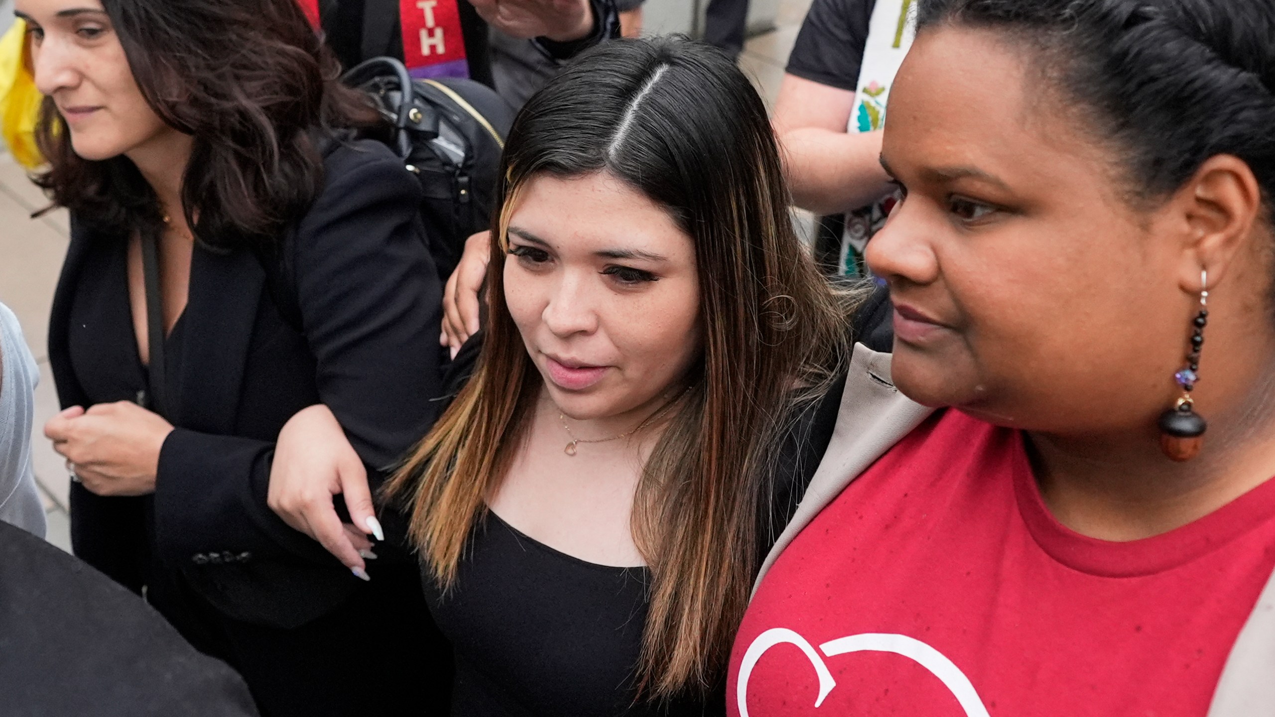 Jennifer Vasquez Sura, wife of Kilmar Abrego Garcia, center, is escorted out of the Federal Courthouse on Friday, June 13, 2025, in Nashville, Tenn. (AP Photo/George Walker IV)