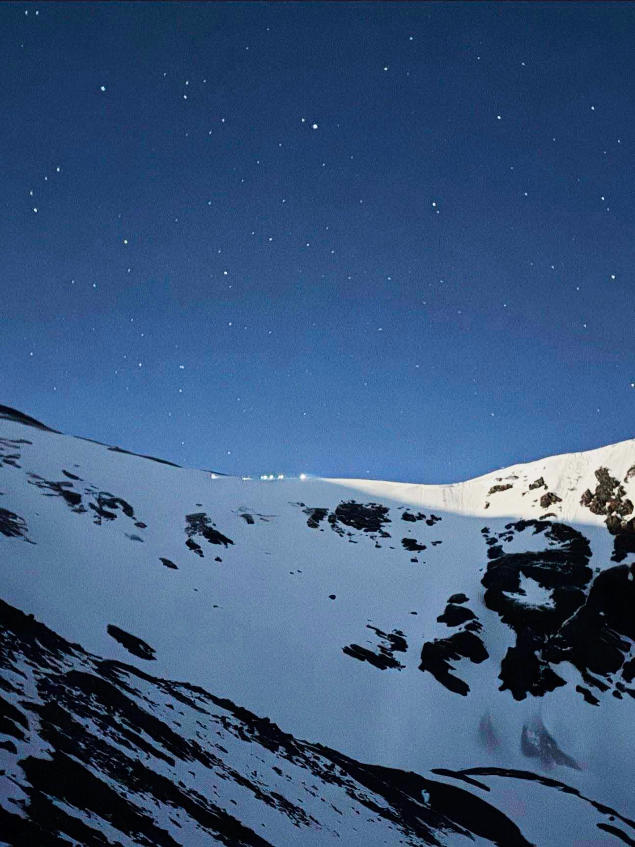 In this image provided by the Alpine Rescue Team, lamps are illuminated on a ridge as Alpine Rescue Team members take part in helping get two men struck by lightning off Torreys Peak in Colorado, Thursday, June 12, 2025. (Jake Smith/Alpine Rescue Team via AP)