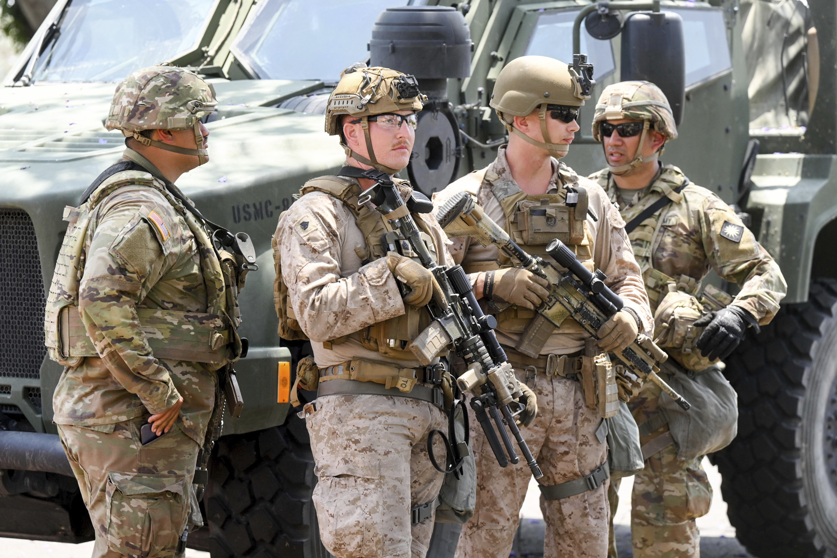 U.S Marines work next to members of the California National Guard outside of a federal building, Friday, June 13, 2025, in Los Angeles (AP Photo/Noah Berger)