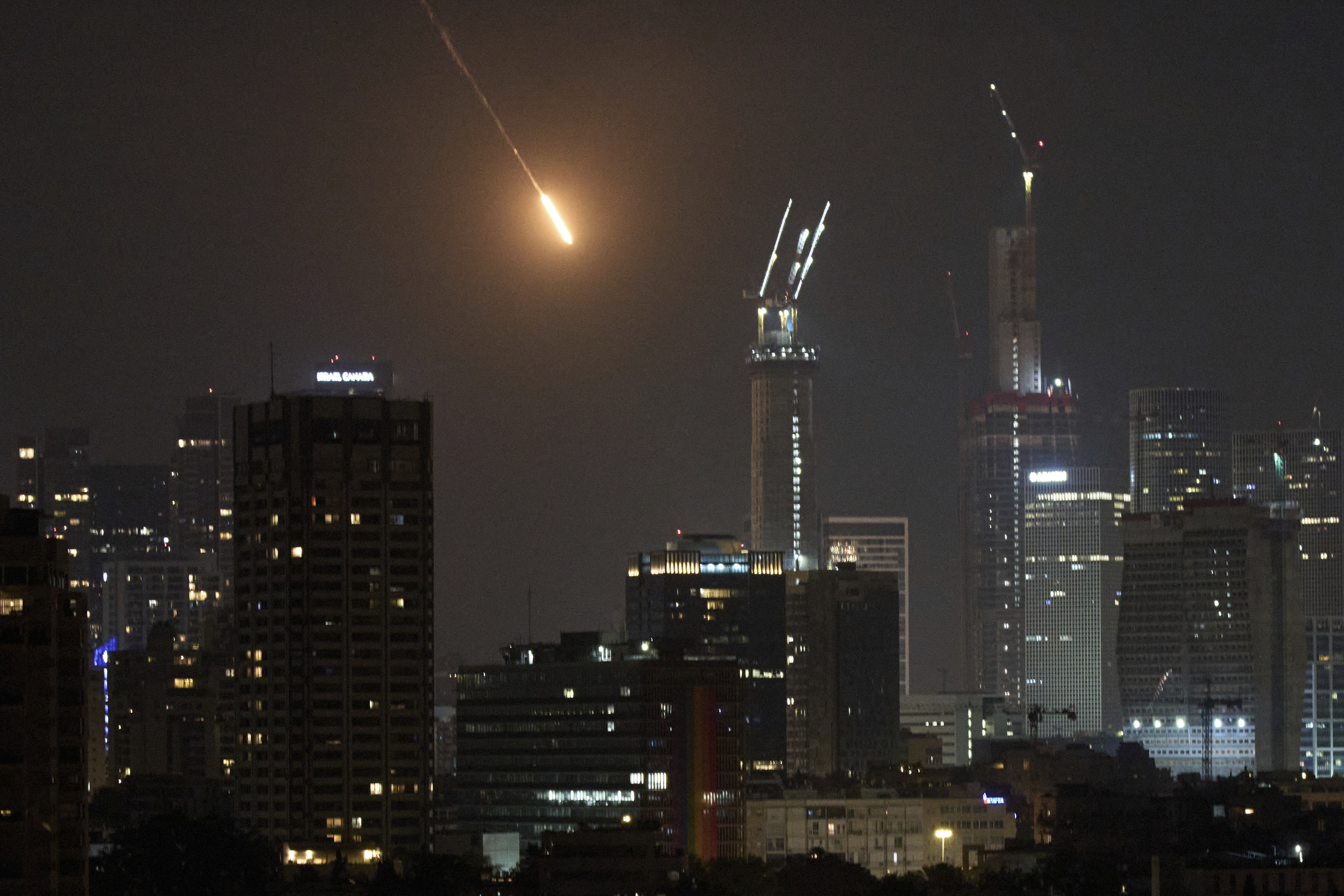 The trace of a projectile is seen before hitting Tel Aviv, Israel, early Saturday, June 14, 2025. (AP Photo/Leo Correa)