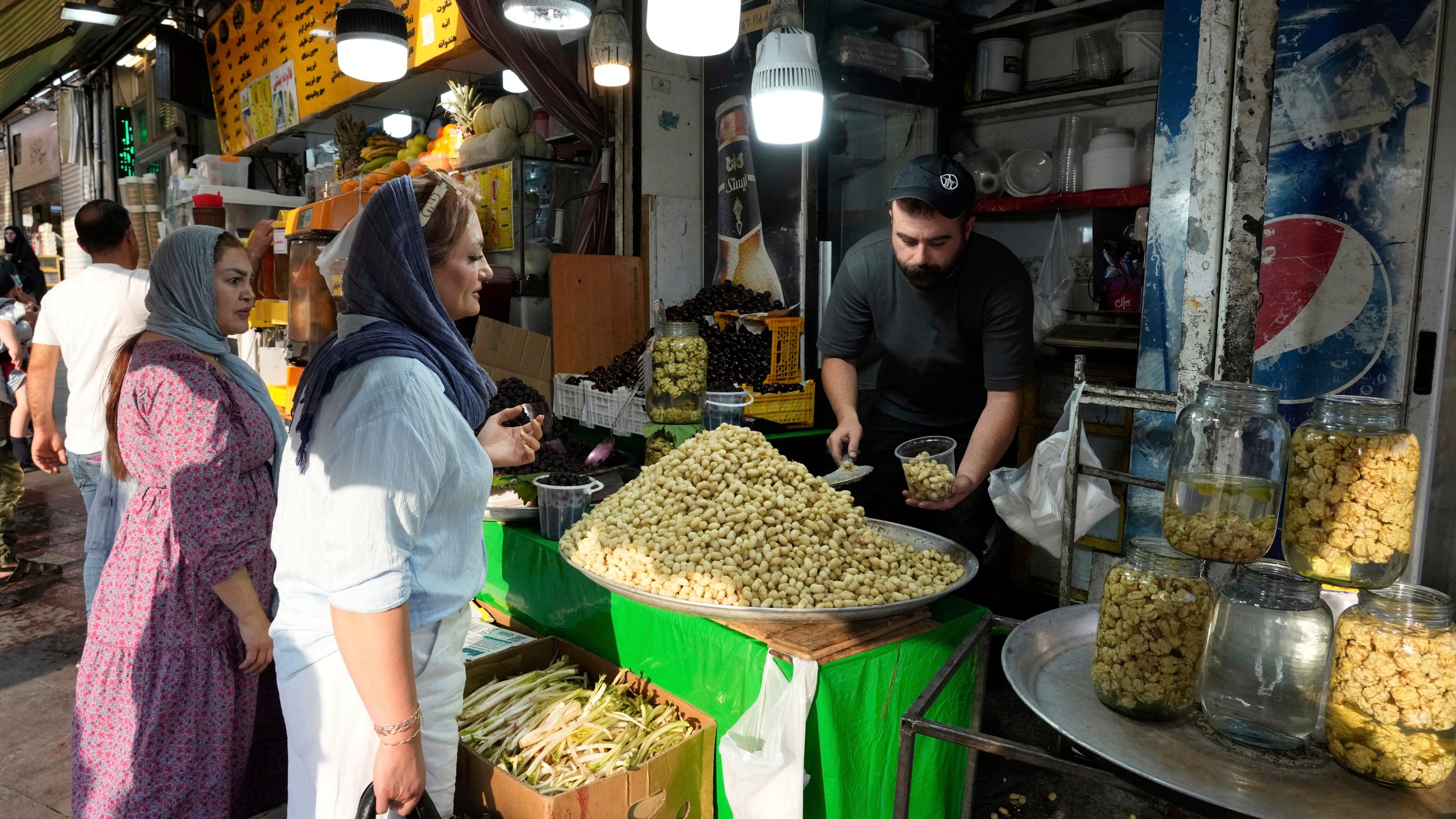 A fruit seller sells Mulberry at Tajrish traditional bazaar in northern Tehran, Iran, Friday, June 13, 2025. (AP Photo/Vahid Salemi)