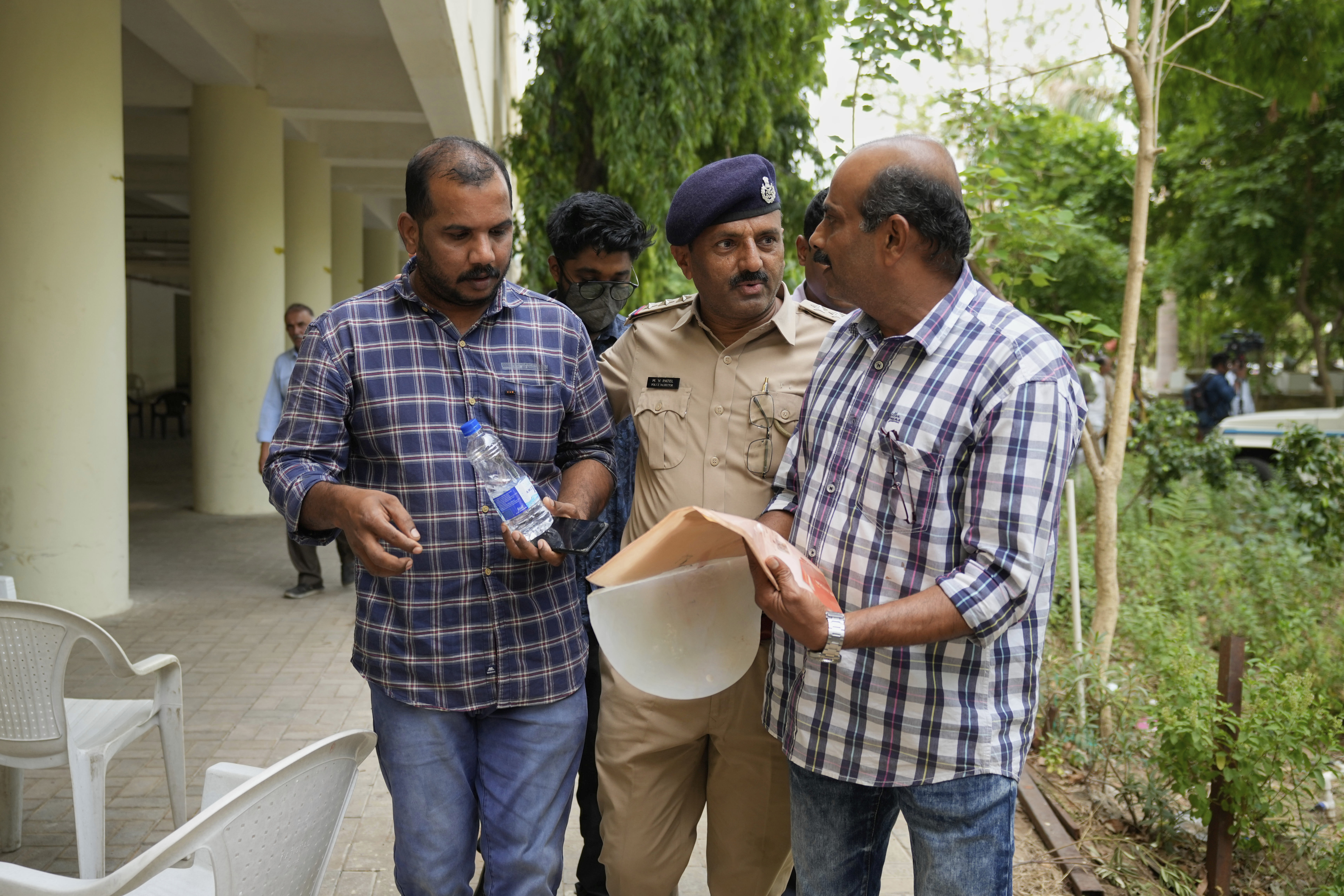 Ratheesh Nair, left, brother of Air India plane crash victim Ranjitha Nair, leaves a hospital after giving his DNA sample to identify his sister's body in Ahmedabad, India, Saturday, June 14, 2025. (AP Photo/Rafiq Maqbool)