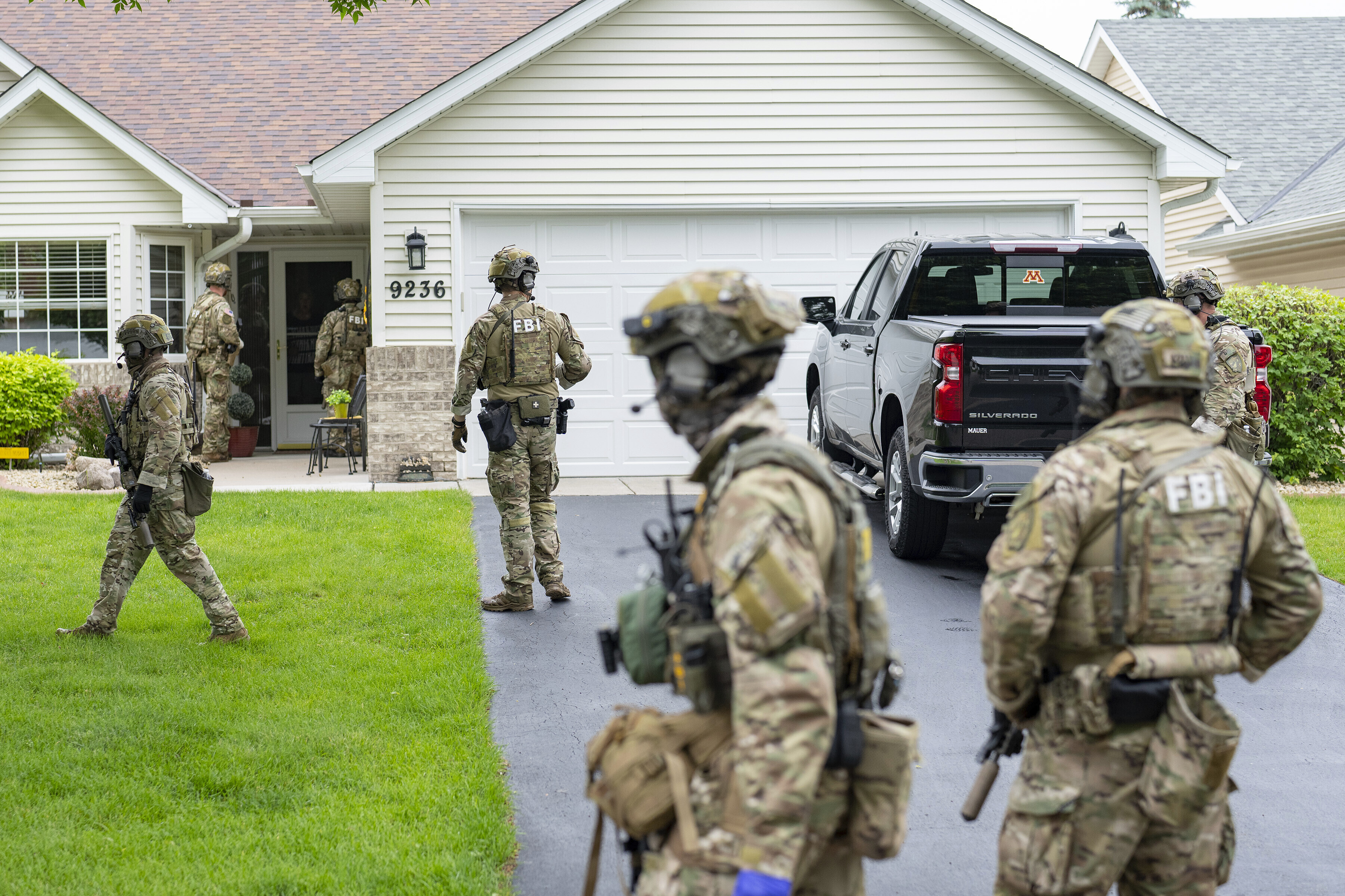 Armed FBI agents search for an active shooter, sweeping a neighborhood adjacent to the home of Minnesota DFL State Representative Melissa Hortman, in Brooklyn Park, Minn., Saturday, June 14, 2025. (Alex Kormann/Star Tribune via AP)