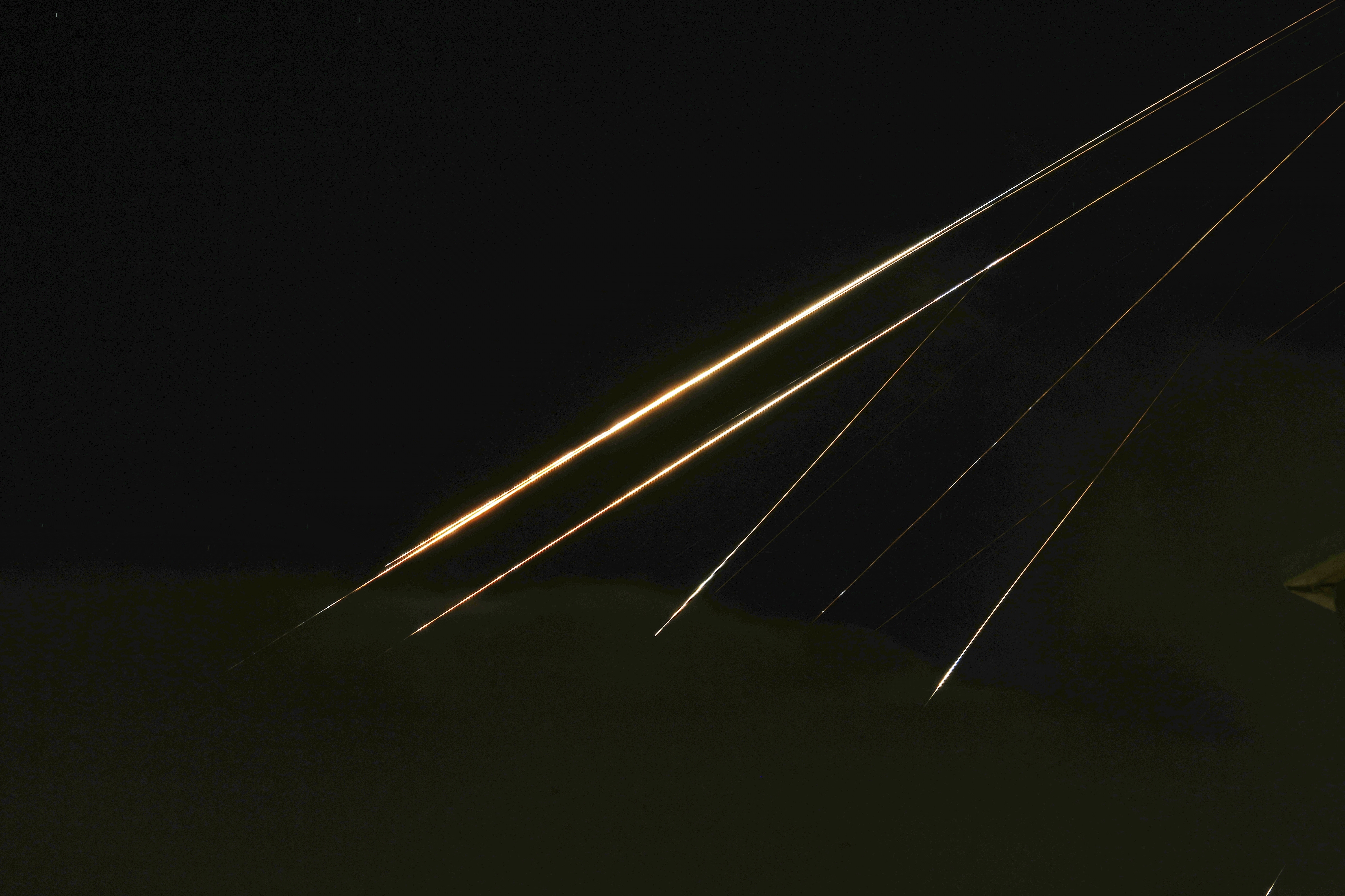 Traces of projectile illuminates the sky seen from northern Israel, Saturday, June 14, 2025. (AP Photo/Ariel Schalit)