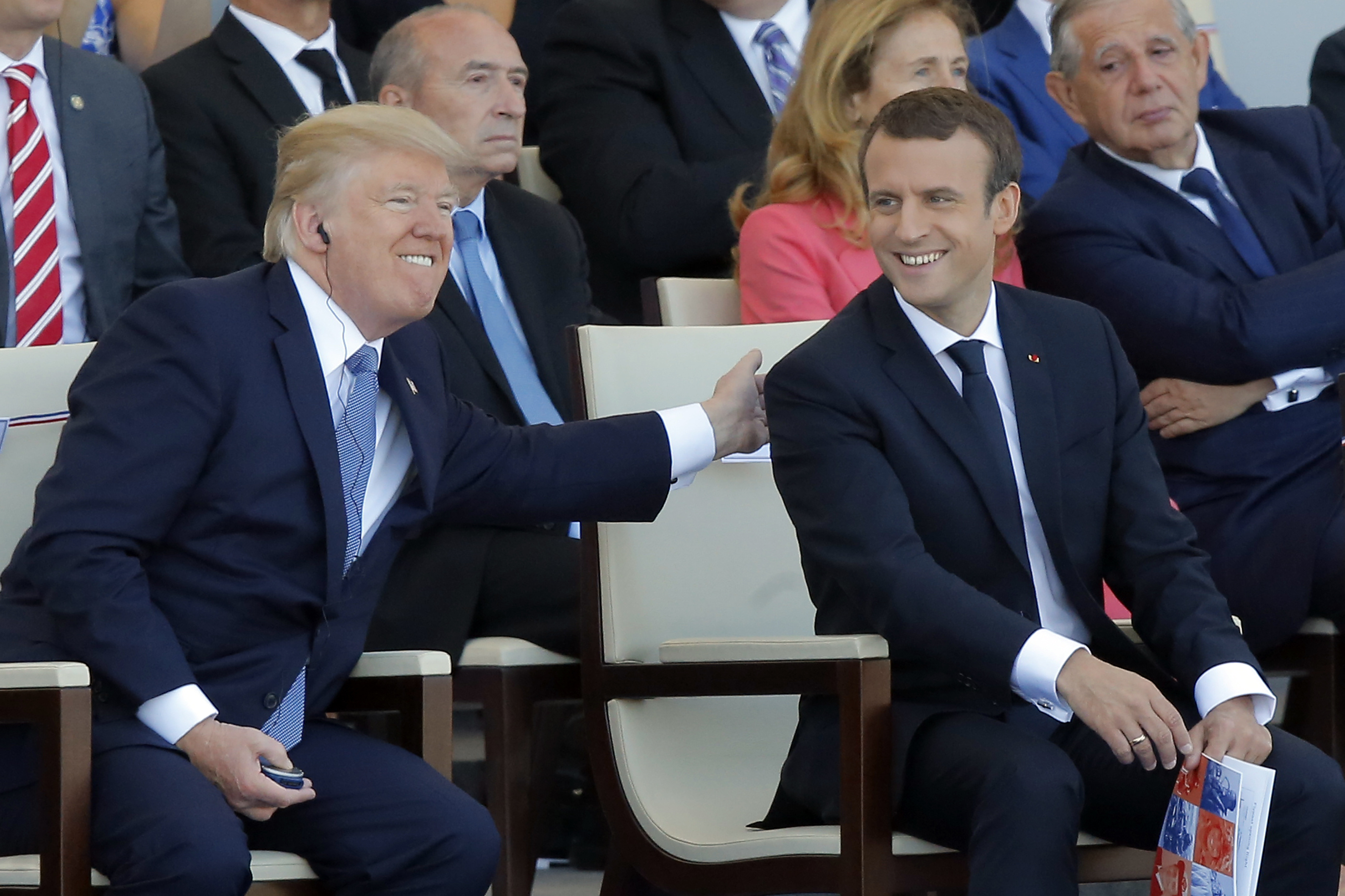 FILE - French President Emmanuel Macron, right, and U.S. President Donald Trump attend the traditional Bastille Day military parade July 14, 2017, on the Champs Elysees, in Paris. (AP Photo/Michel Euler, File)