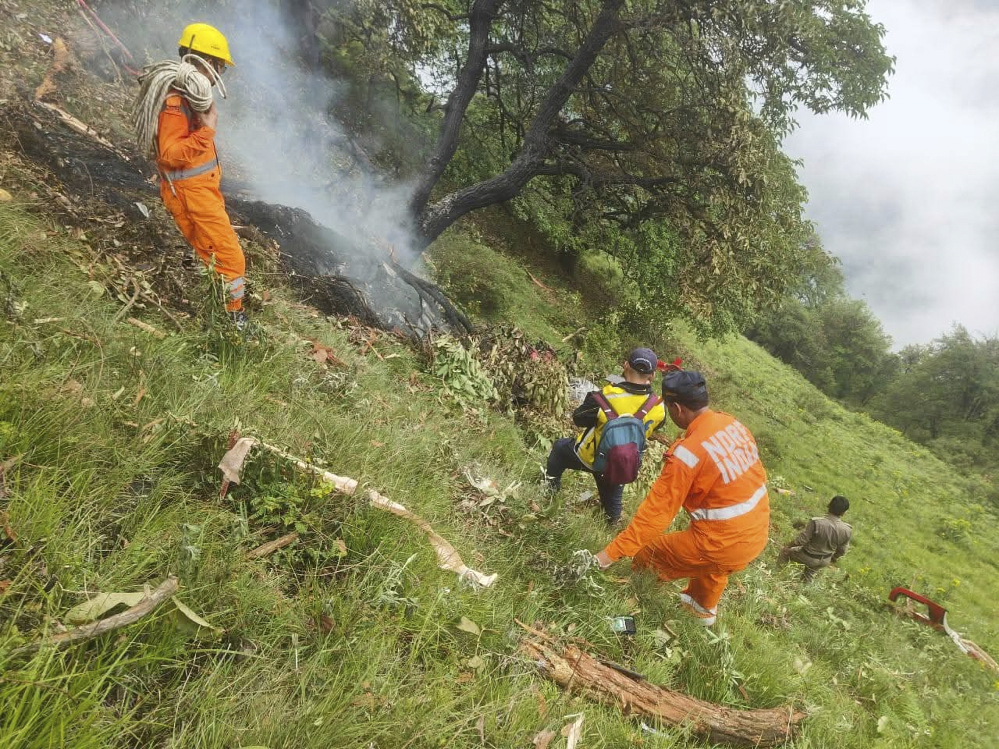 This photo shared by Uttarakhand Police on the X platform shows rescuers working at the site of a helicopter crash near Kedarnath, in Uttarakhand, India, Sunday, June 15, 2025. (Uttarakhand Police on X via AP)
