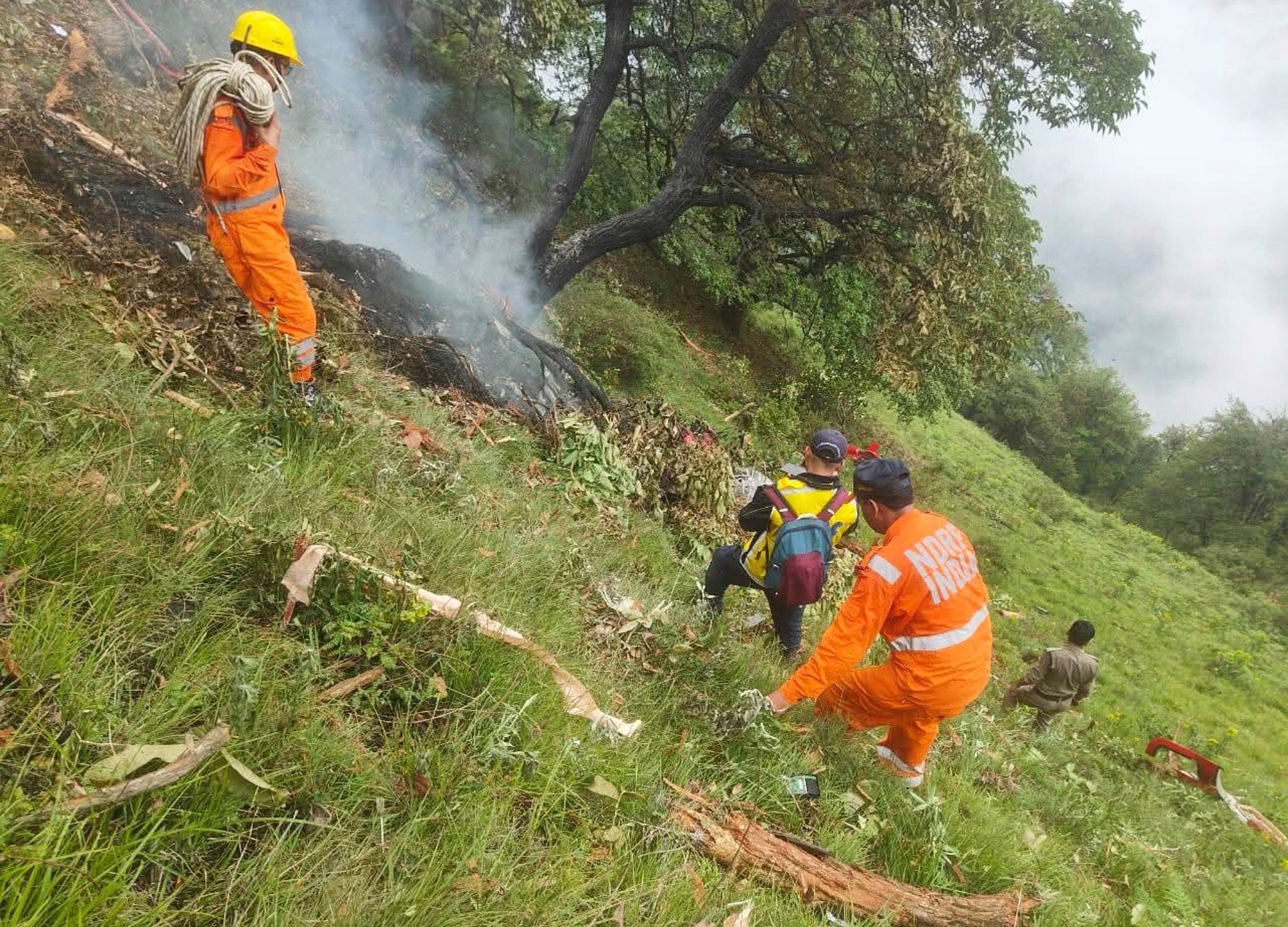 This photo shared by Uttarakhand Police on the X platform shows rescuers working at the site of a helicopter crash near Kedarnath, in Uttarakhand, India, Sunday, June 15, 2025. (Uttarakhand Police on X via AP)