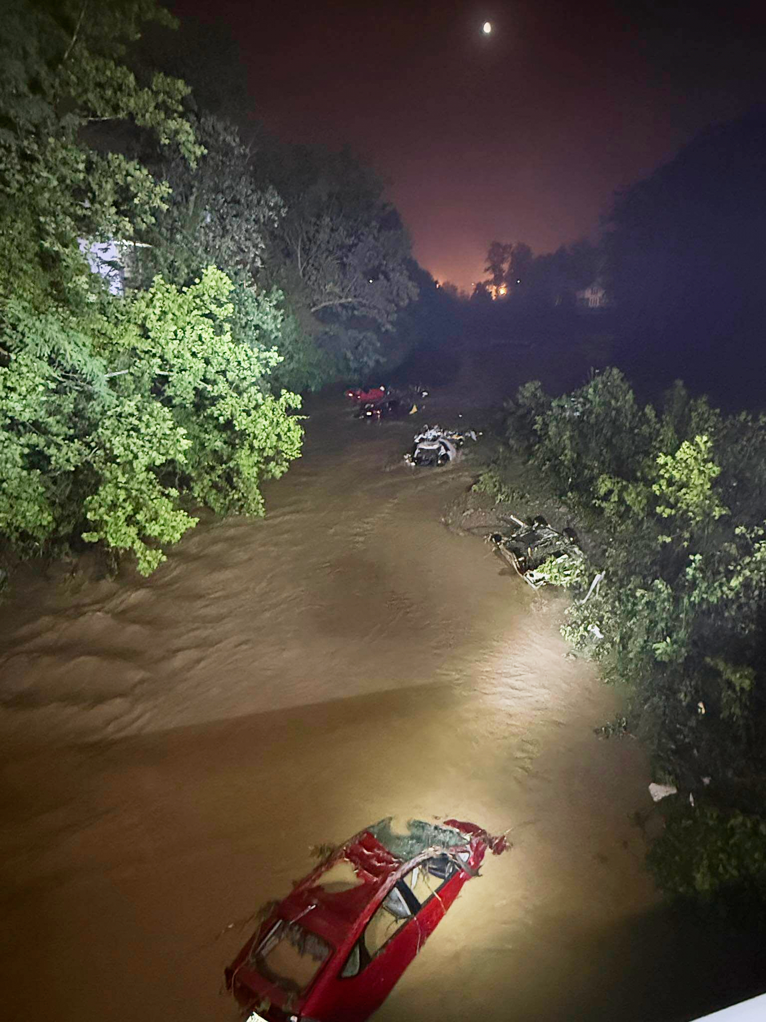 In this image provided by the Wheeling West Virginia Fire Department, cars sit submerged in floodwaters, Saturday, June 14, 2025, in Wheeling, W.V. (Wheeling West Virginia Fire Department via AP)