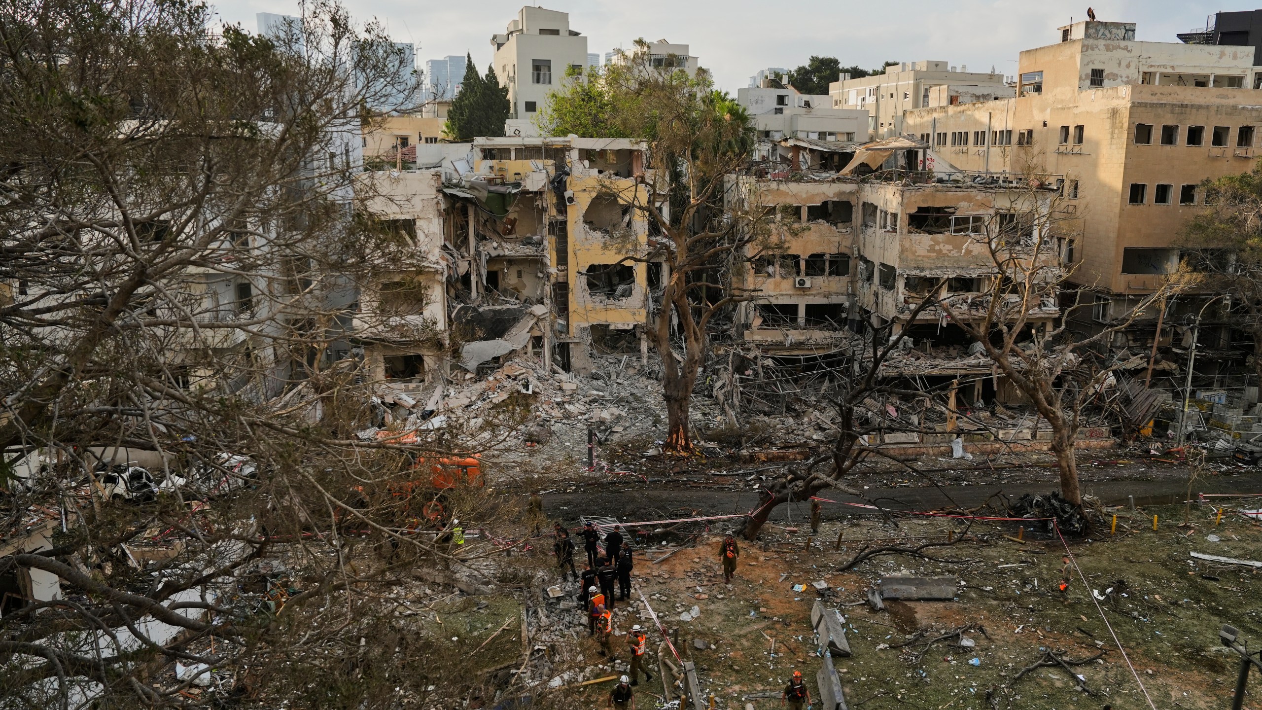 Rescue team work at the site where a missile launched from Iran struck Tel Aviv, Israel, Monday, June 16, 2025. (AP Photo/Baz Ratner)