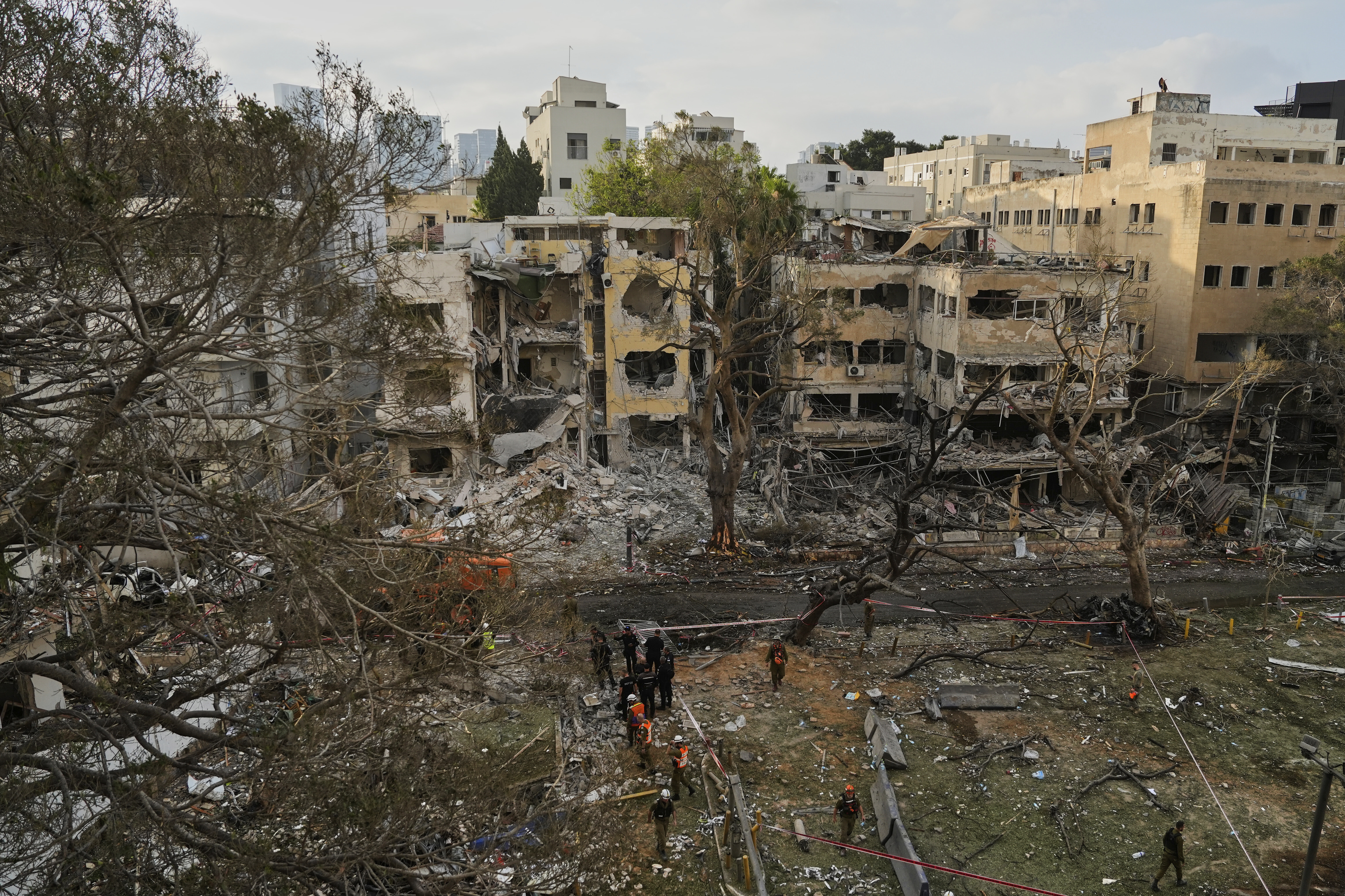 Rescue team work at the site where a missile launched from Iran struck Tel Aviv, Israel, Monday, June 16, 2025. (AP Photo/Baz Ratner)