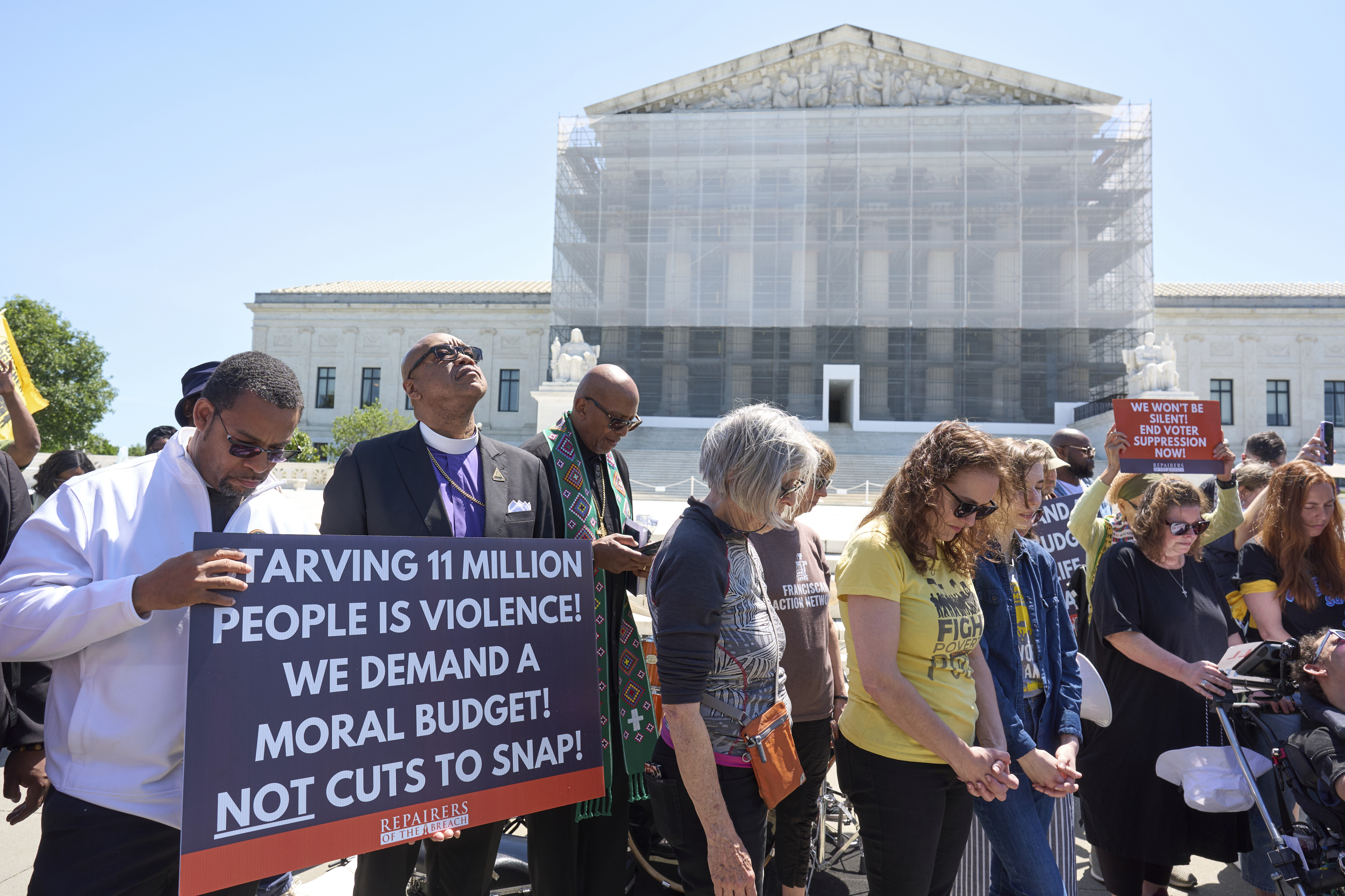Activists with the Poor People's Campaign protest against spending reductions across Medicaid, food stamps and federal aid in President Donald Trump's spending and tax bill being worked on by Senate Republicans this week, outside the Supreme Court in Washington, Monday, June 2, 2025. (AP Photo/J. Scott Applewhite)