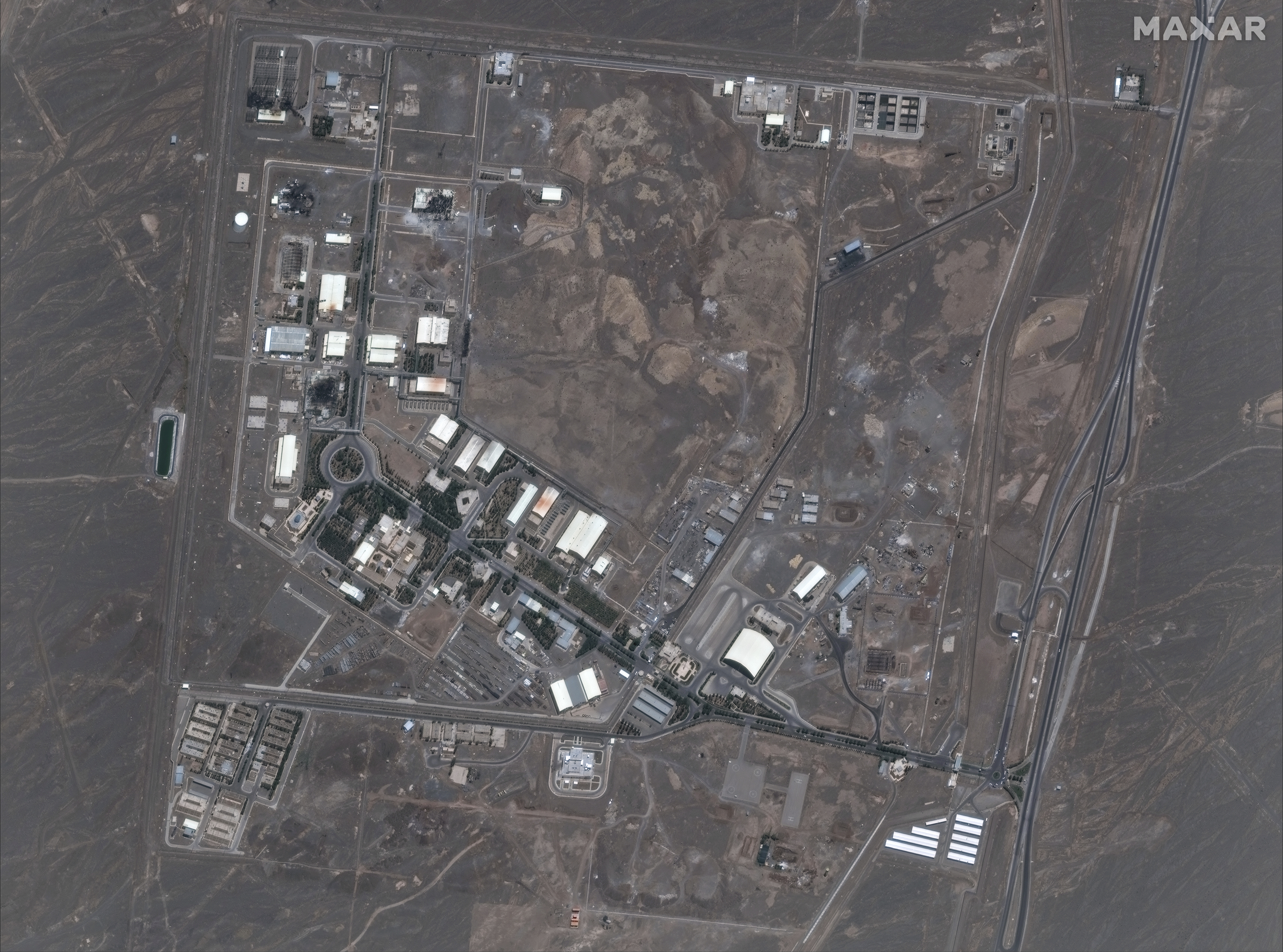 This satellite image provided by Maxar Technologies shows the Natanz nuclear enrichment facility, where multiple buildings were destroyed from recent Israeli airstrikes, 135 miles southeast of Tehran, Iran, Saturday, June 14, 2025. (Maxar Technologies via AP)