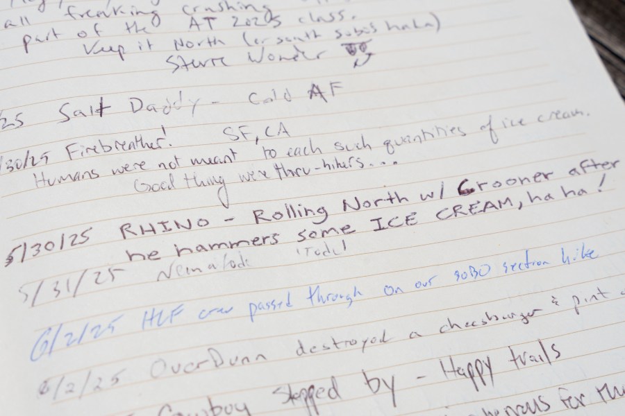 Entries in a hiker logbook at Pine Grove Furnace State Park in Pennsylvania on Tuesday, June 10, 2025. (AP Photo/Mingson Lau)