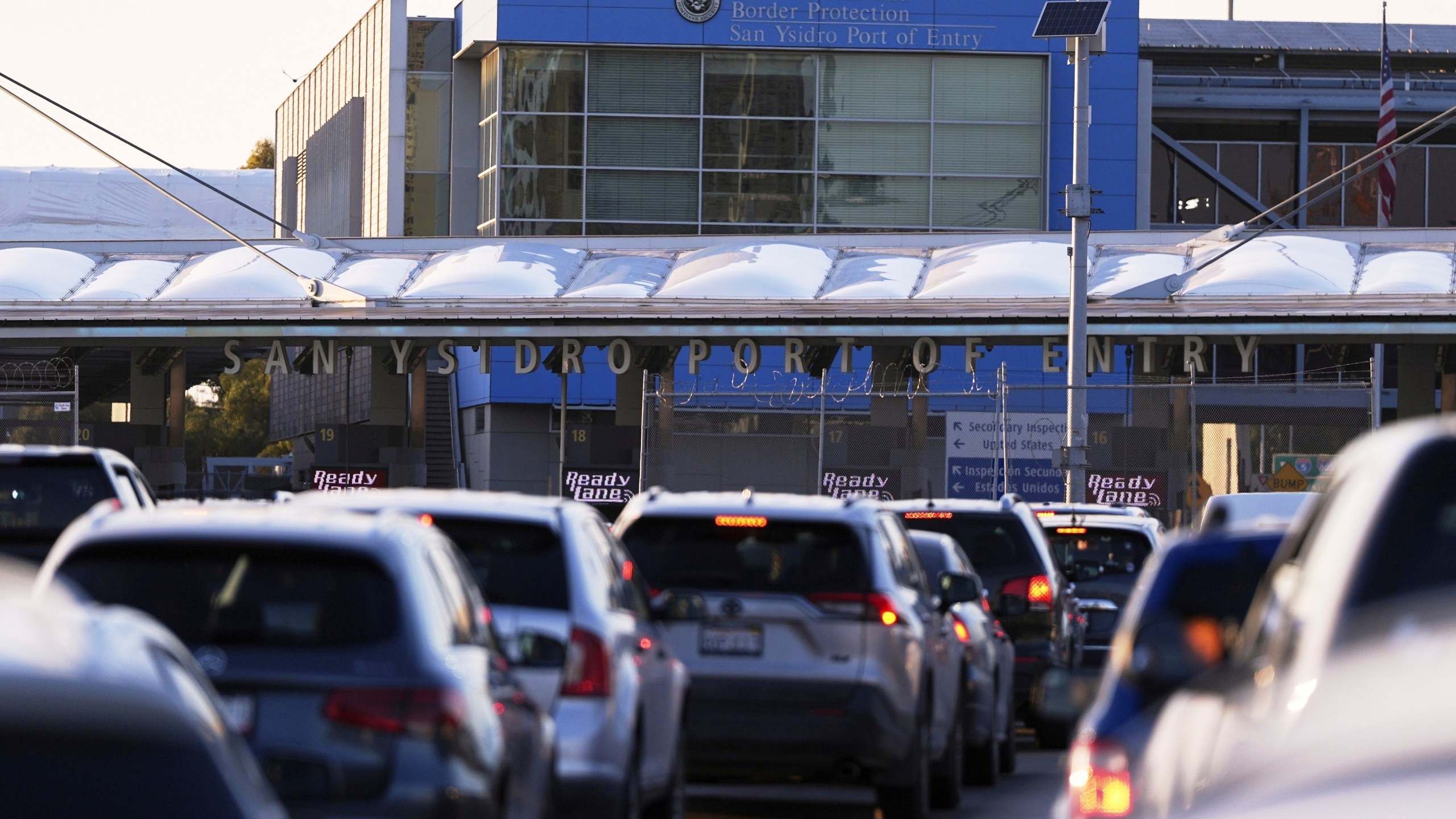 FILE - Vehicles wait in line to cross the border into the United States at the San Ysidro Port of Entry, March 18, 2025, in Tijuana, Mexico. (AP Photo/Gregory Bull, File)
