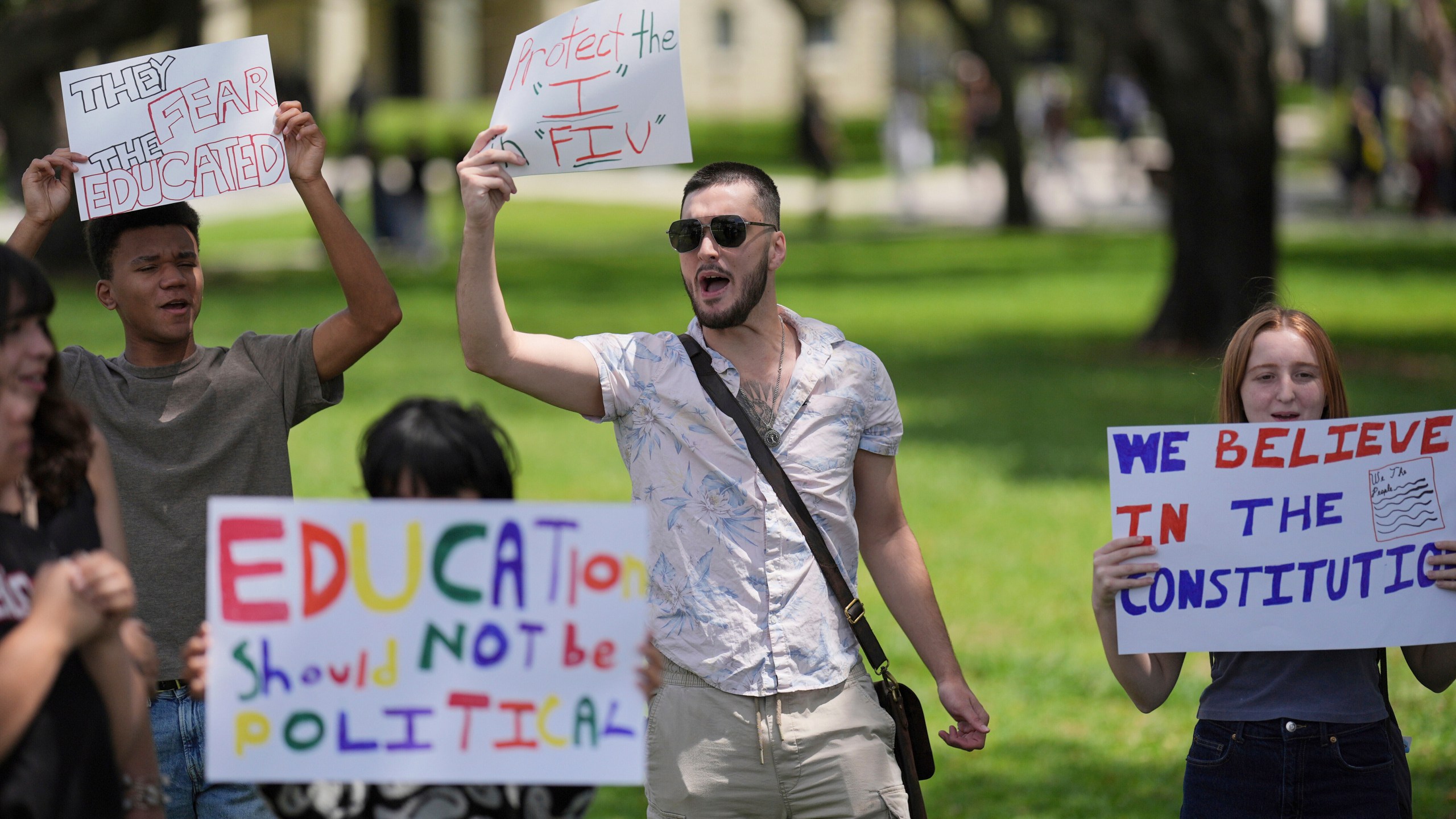 FILE - A group of Florida International University students protest against cuts in federal funding and an agreement by campus police to partner with Immigration and Customs Enforcement, on the FIU campus on a day of protests around the country in support of higher education, April 17, 2025, in Miami. (AP Photo/Rebecca Blackwell, File)