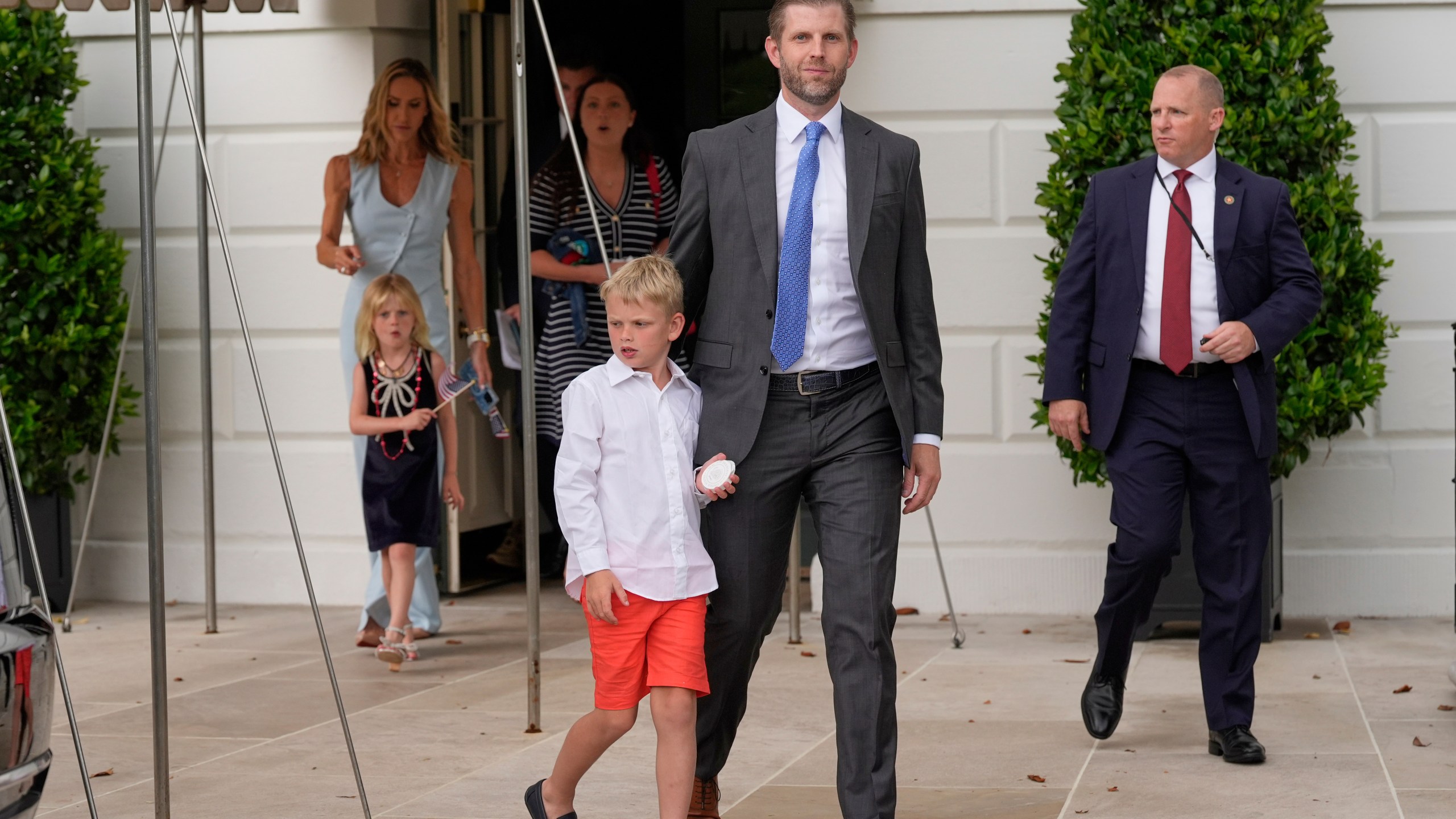 Eric Trump and his wife Lara, along with their children, depart the White House with President Donald Trump and first lady Melania Trump ahead of an parade to honor the Army's 250th anniversary, coinciding with Trump's 79th birthday, Saturday, June 14, 2025, in Washington. (AP Photo/Mark Schiefelbein)