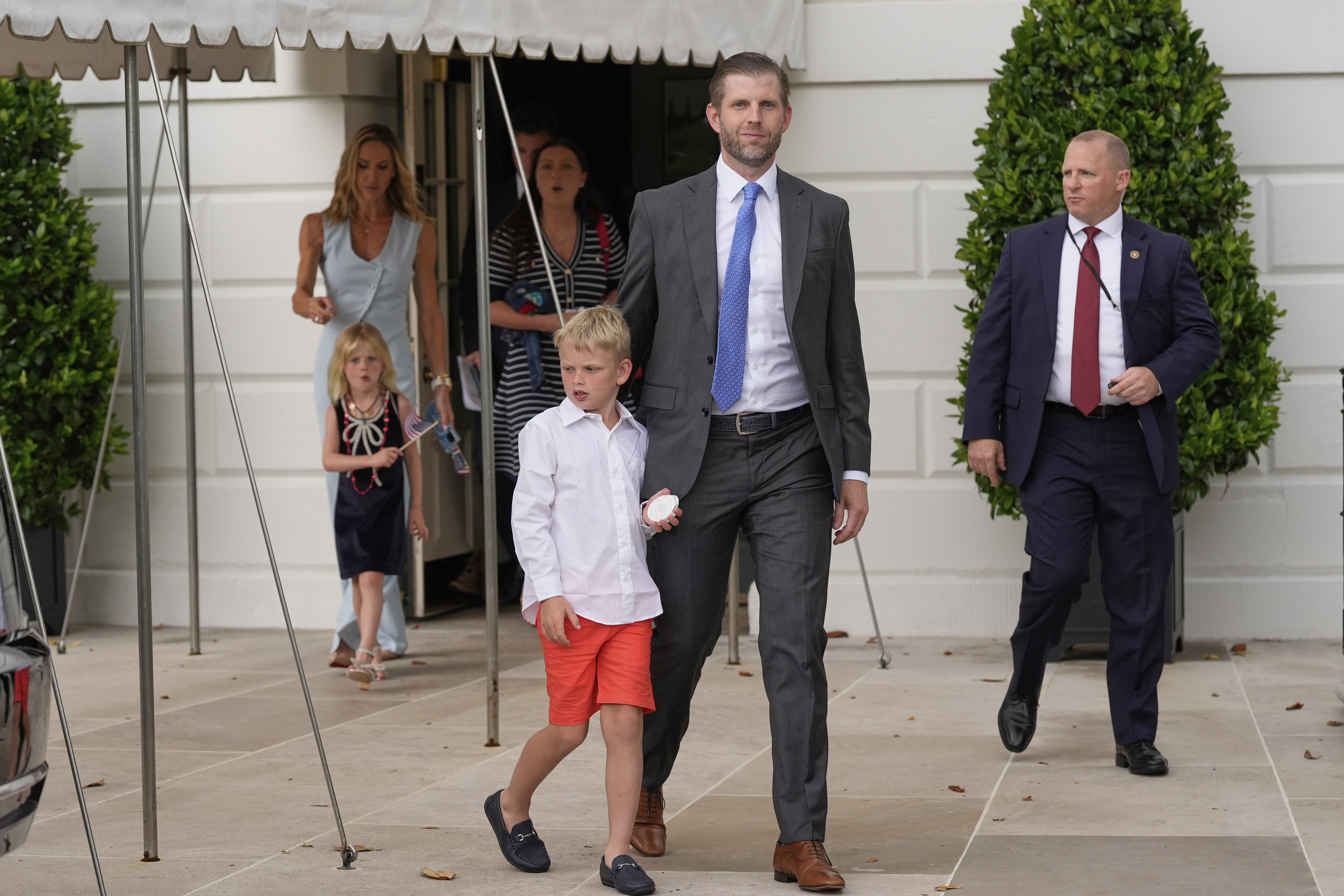 Eric Trump and his wife Lara, along with their children, depart the White House with President Donald Trump and first lady Melania Trump ahead of an parade to honor the Army's 250th anniversary, coinciding with Trump's 79th birthday, Saturday, June 14, 2025, in Washington. (AP Photo/Mark Schiefelbein)