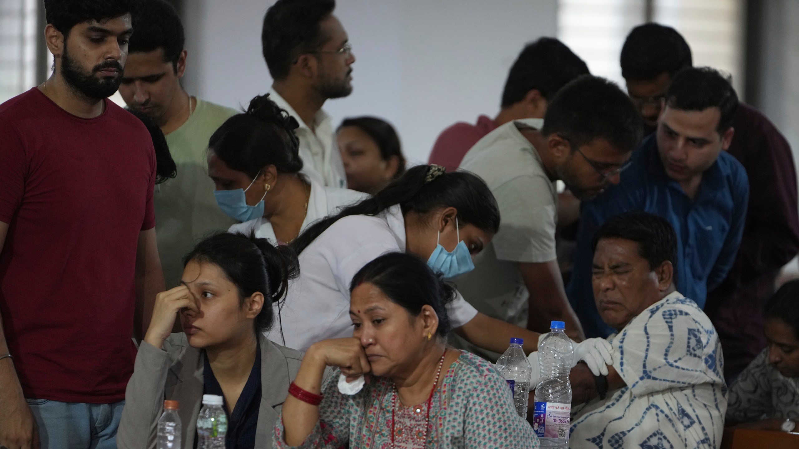A health worker take DNA sample of a family member of a victim of an airplane that crashed in India's northwestern city of Ahmedabad in Gujarat state, Friday, June 13, 2025. (AP Photo/Ajit Solanki)
