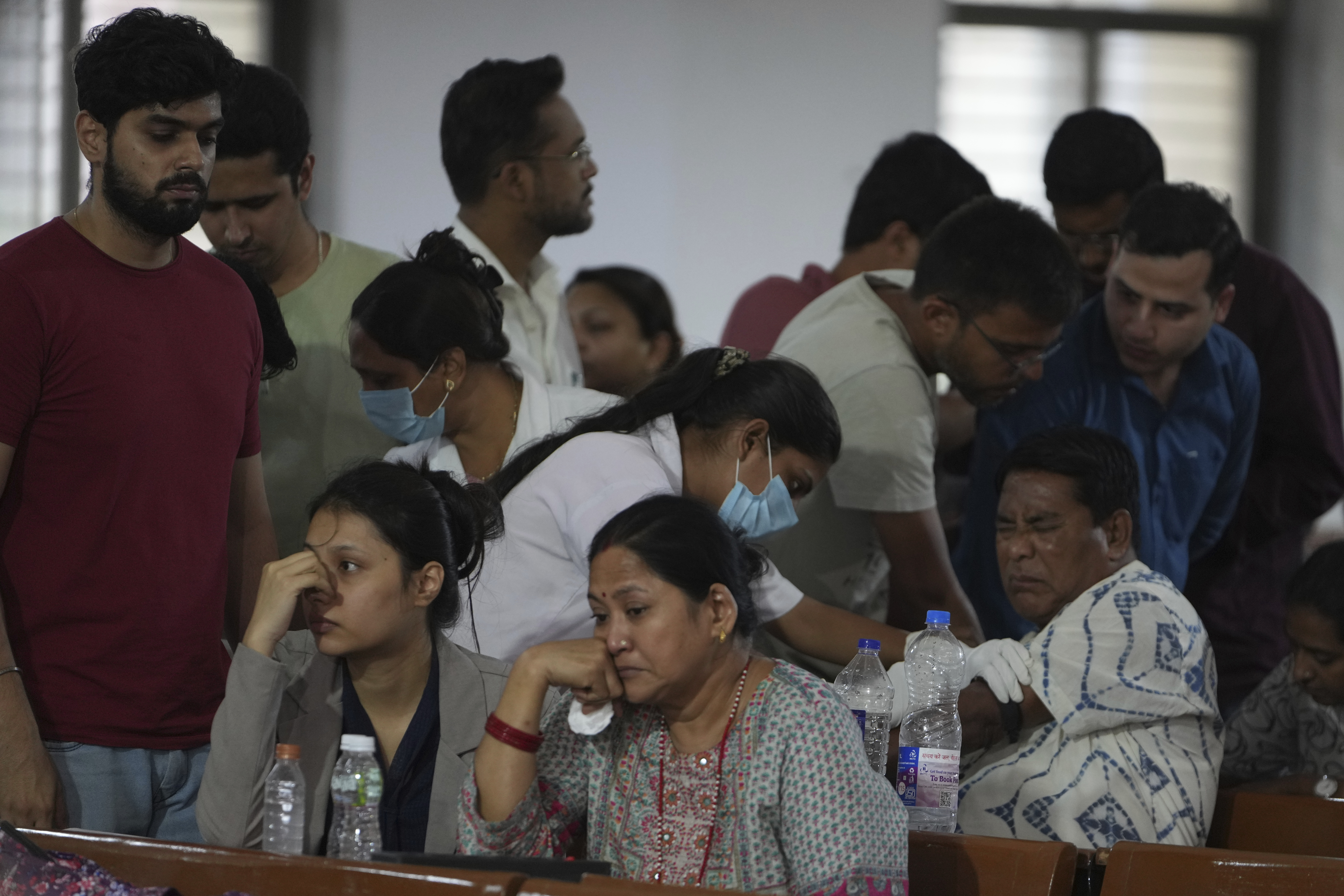 A health worker take DNA sample of a family member of a victim of an airplane that crashed in India's northwestern city of Ahmedabad in Gujarat state, Friday, June 13, 2025. (AP Photo/Ajit Solanki)