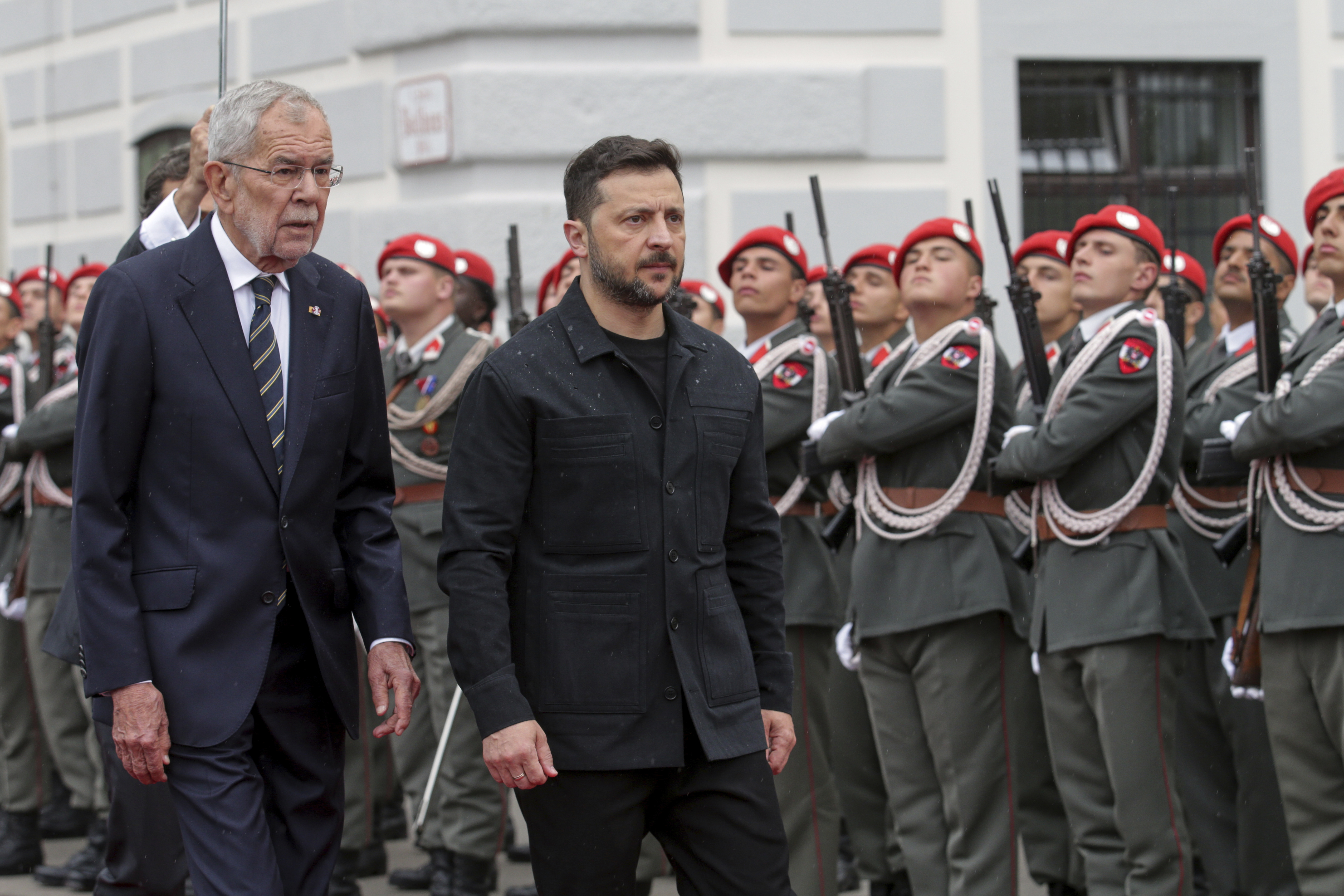 Ukraine's President Volodymyr Zelenskyy, right, and Austrian President Alexander van Der Bellen walk past the honour guard in Vienna, Austria, Monday, June 16, 2025. (AP Photo/Heinz-Peter Bader)
