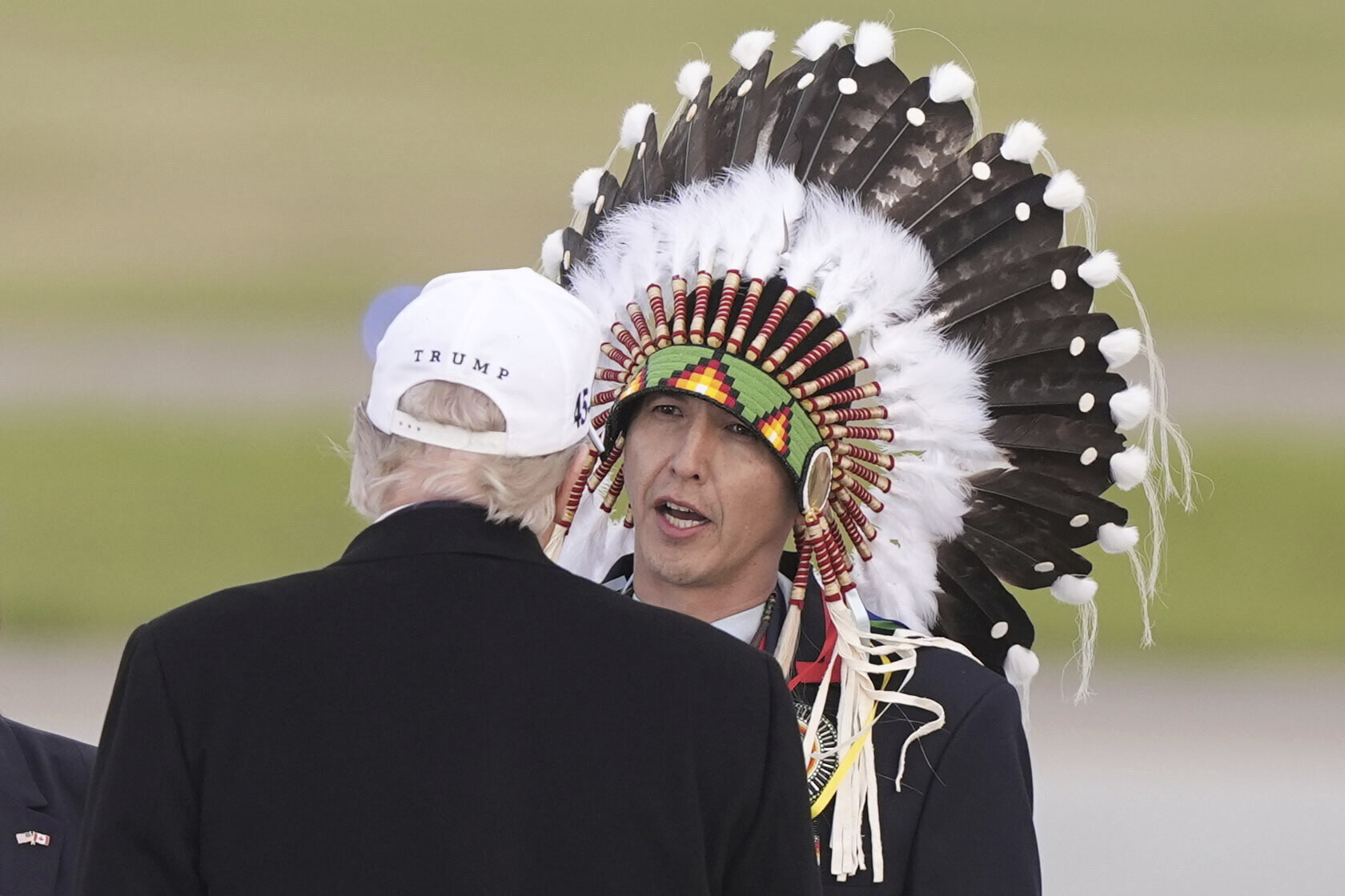 President Donald Trump is greeted by Steven Crowchild of the Tsuut'ina First Nation, as he arrives at Calgary International Airport, Sunday, June 15, 2025, in Calgary, Canada, ahead of the G7 Summit. (AP Photo/Gerald Herbert)