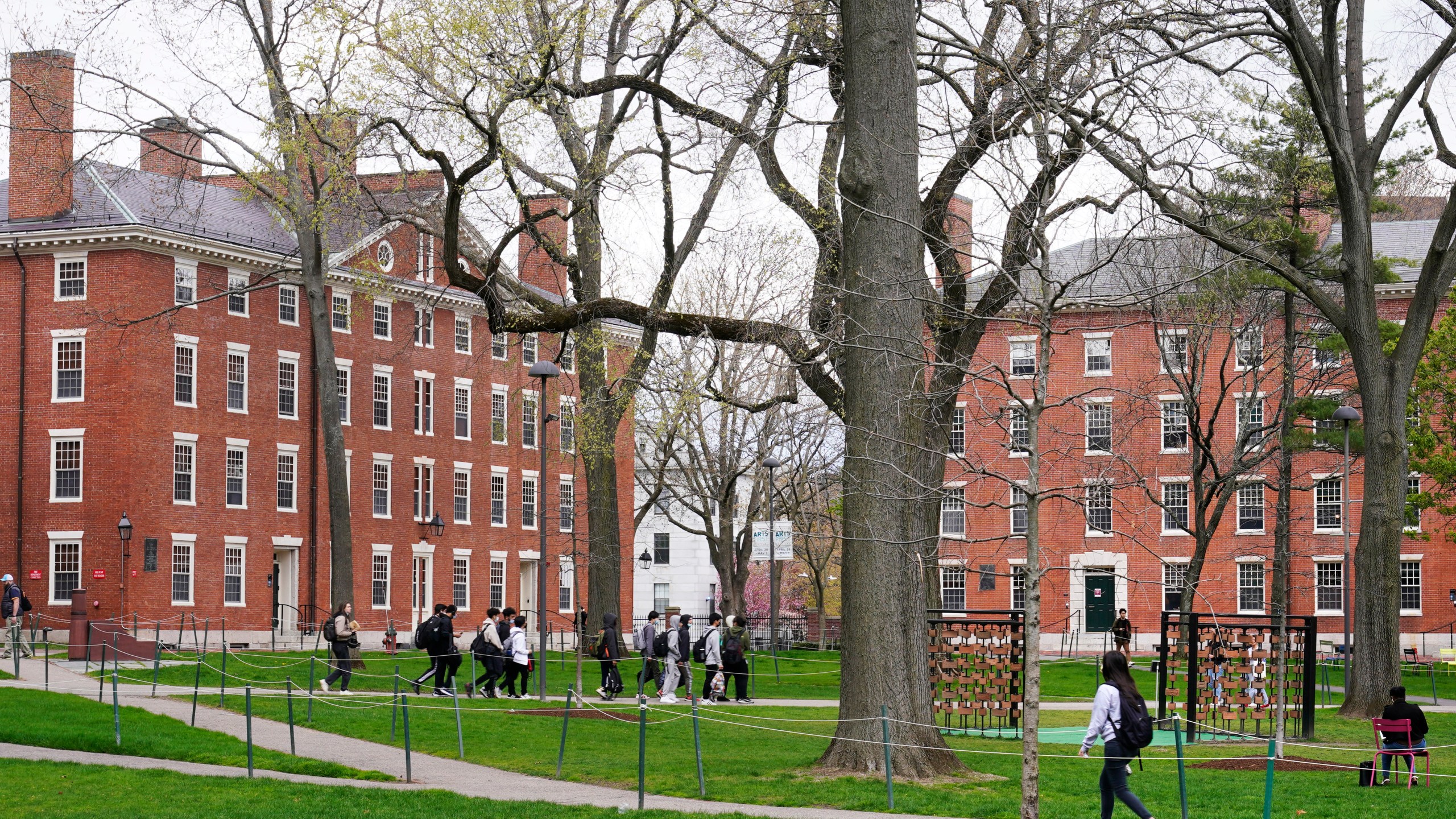 FILE - Students walk through Harvard Yard, April 27, 2022, on the campus of Harvard University in Cambridge, Mass. (AP Photo/Charles Krupa, File)