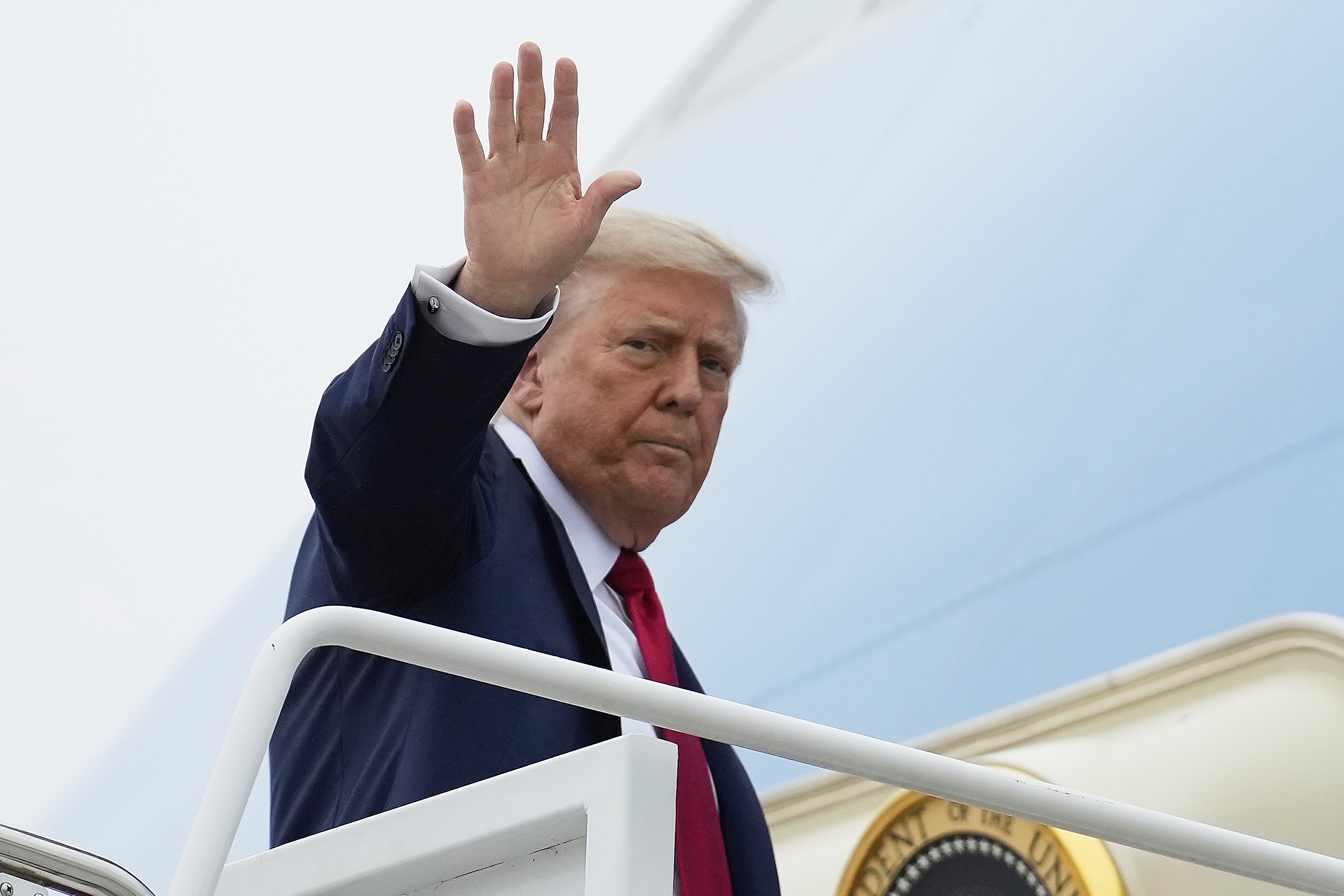 President Donald Trump waves as he boards Air Force One, Sunday, June 15, 2025, at Joint Base Andrews, Md., for a trip to Canada to attend the G7 Summit. (AP Photo/Mark Schiefelbein)