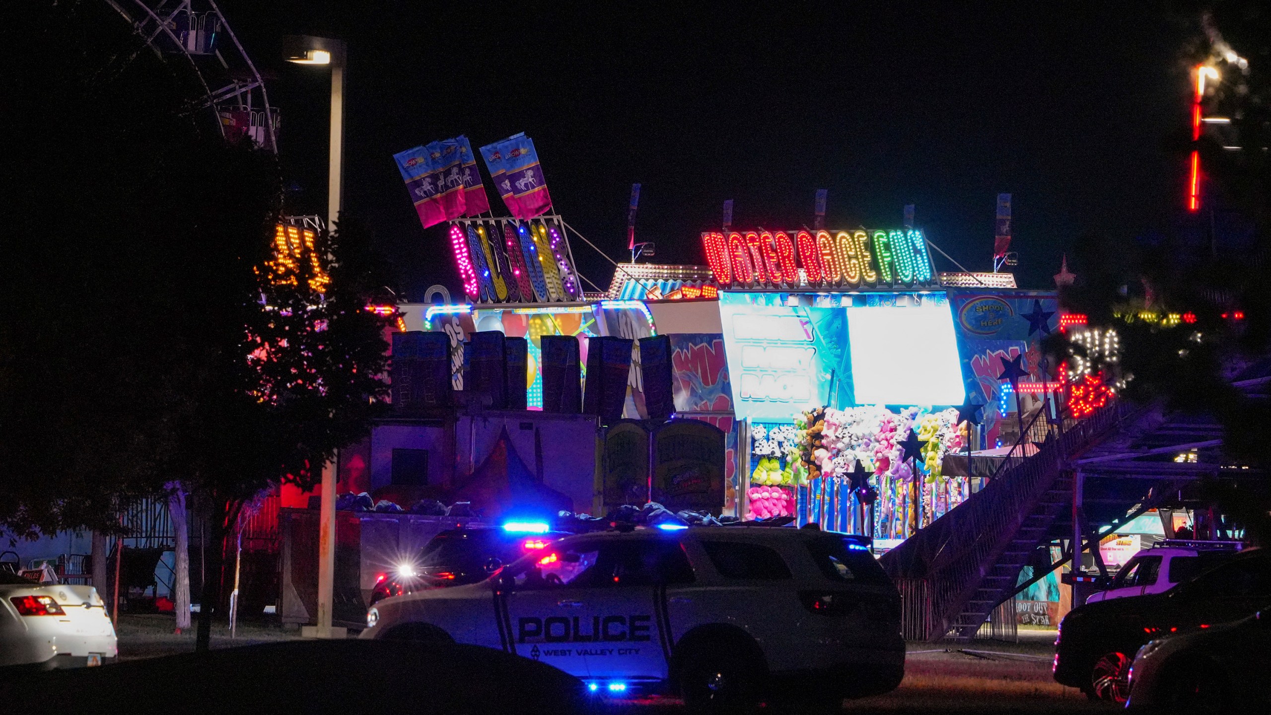 Law enforcement investigate after a reported shooting at WestFest in West Valley City, Utah, June 15, 2025. (Chris Samuels/The Salt Lake Tribune via AP) **NOT AN AP MEMBER**