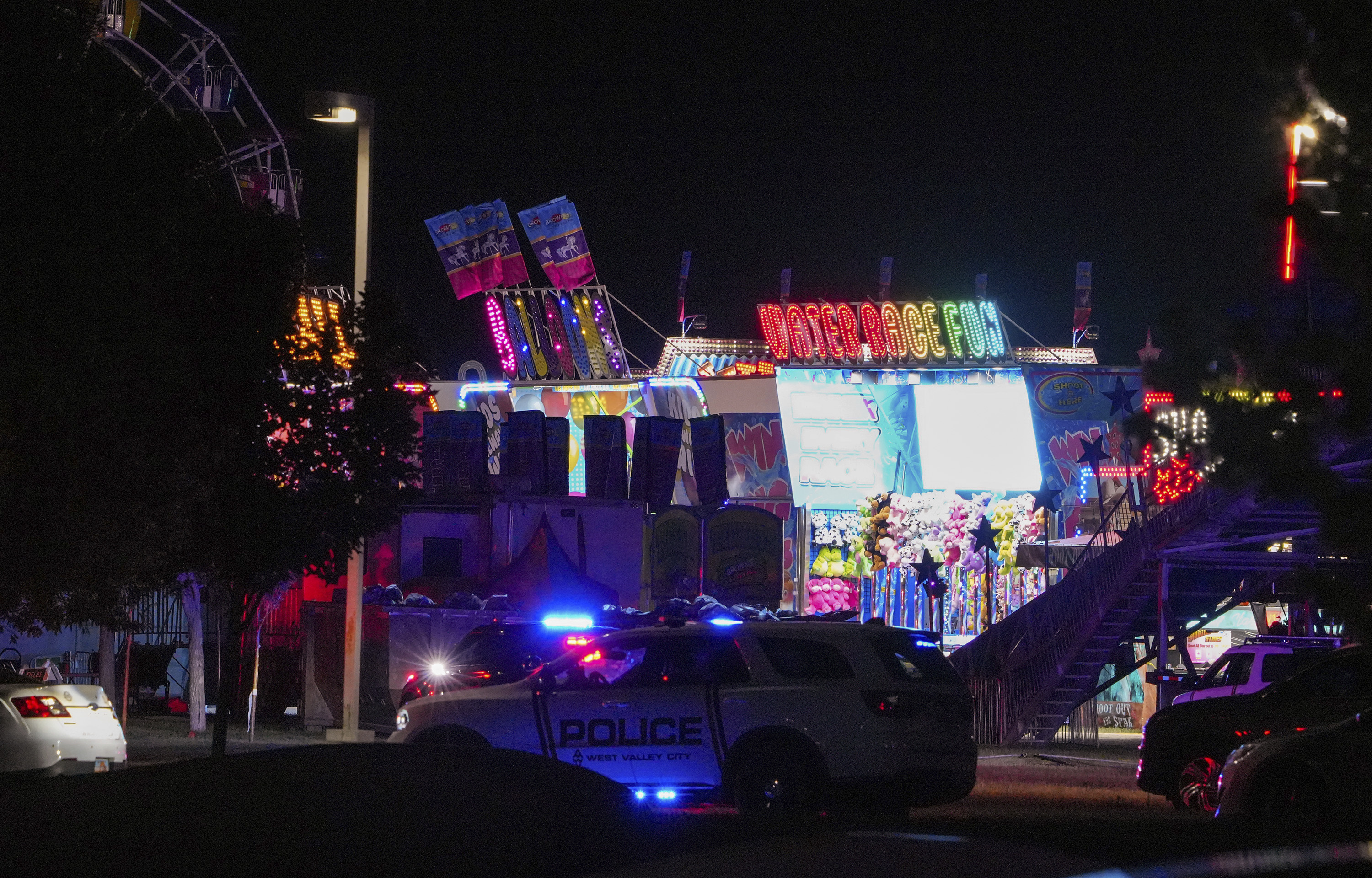Law enforcement investigate after a reported shooting at WestFest in West Valley City, Utah, June 15, 2025. (Chris Samuels/The Salt Lake Tribune via AP) **NOT AN AP MEMBER**