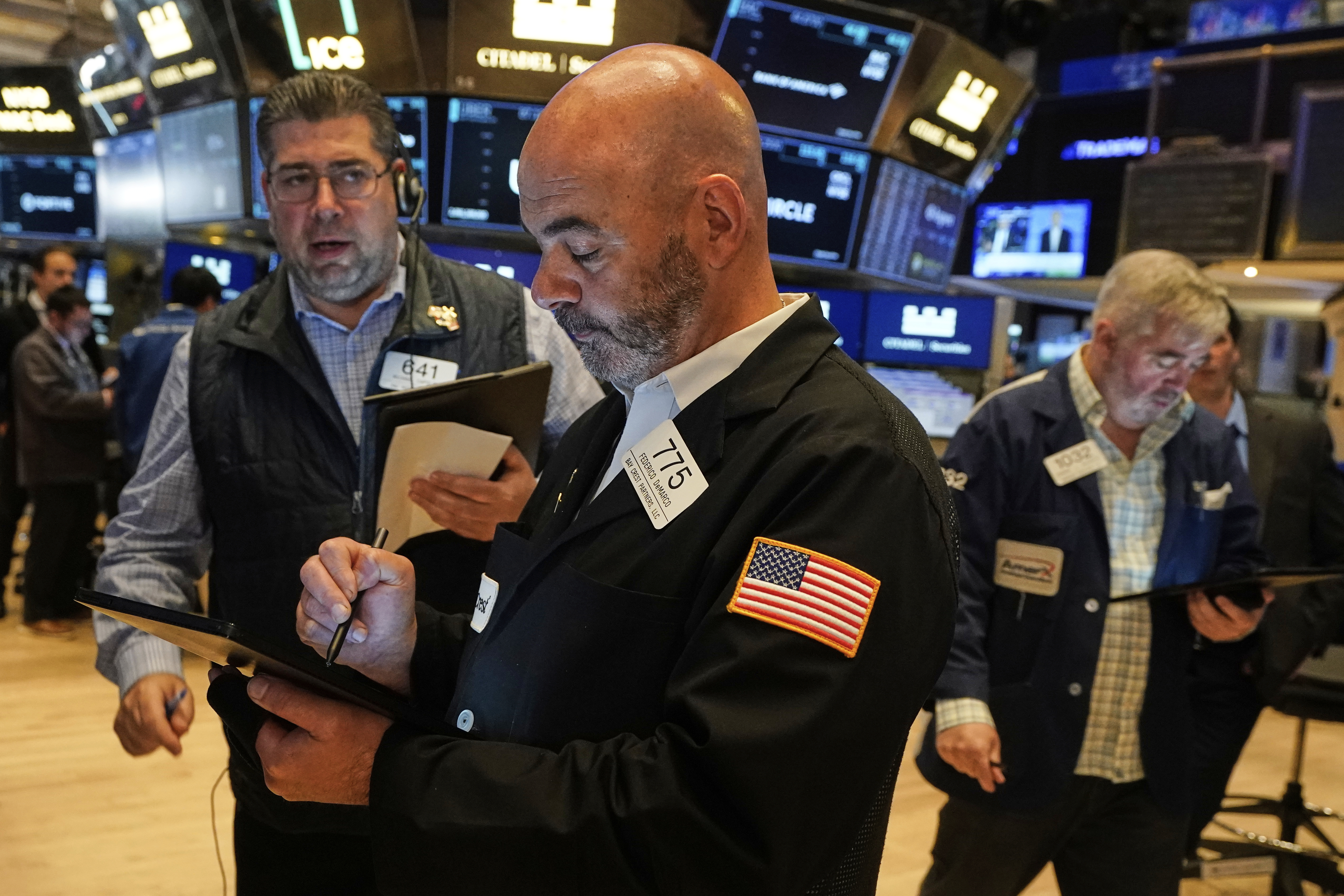 Traders Michael Capolino, left, Fred Demarco, center, and Edward McCarthy work on the floor of the New York Stock Exchange, Tuesday, June 10, 2025. (AP Photo/Richard Drew)