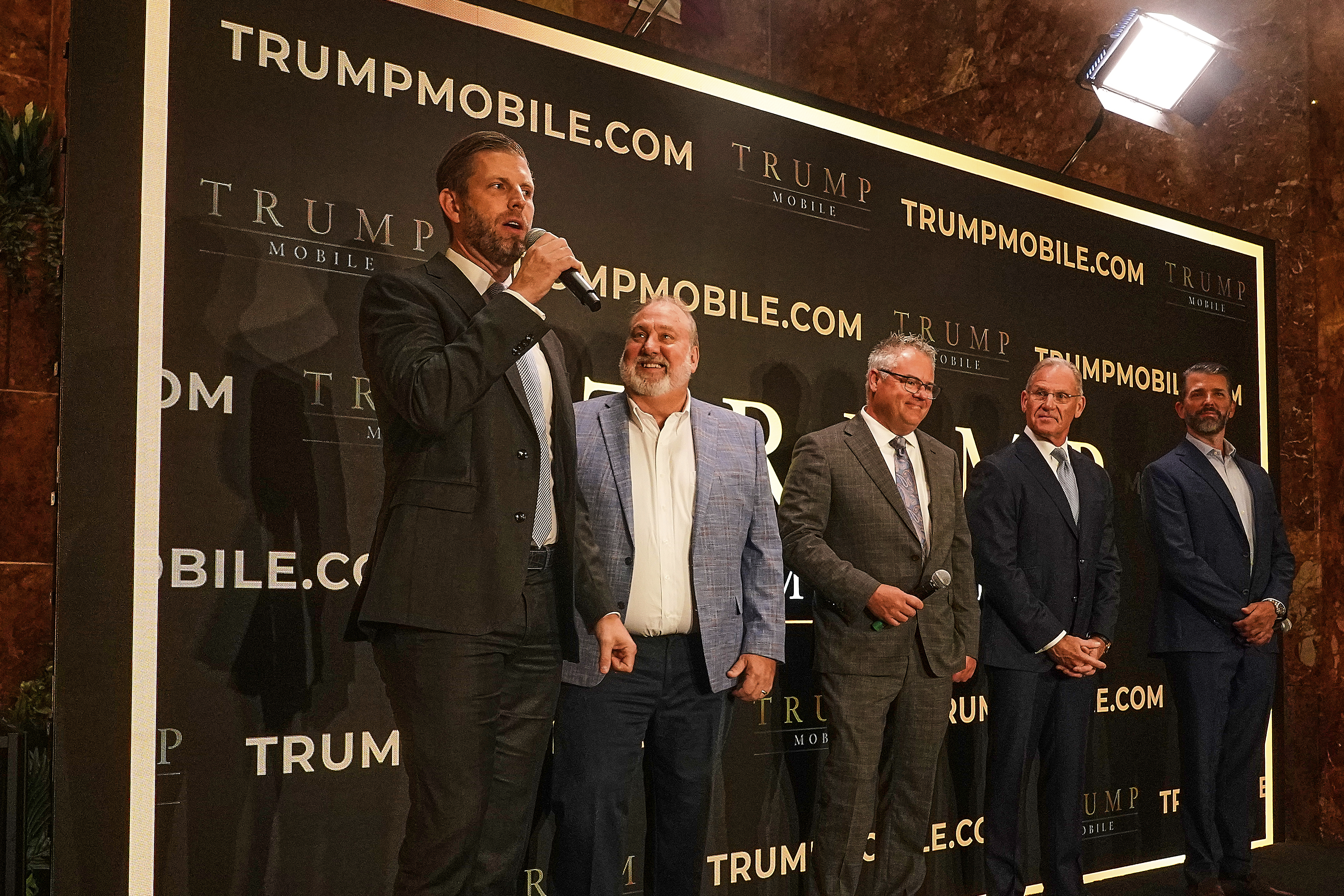 Eric Trump, Don Hendrickson, Eric Thomas, Patrick O'Brien and Donald Trump Jr., left to right, participate in the announcement of Trump Mobile, in New York's Trump Tower, Monday, June 16, 2025. (AP Photo/Richard Drew)