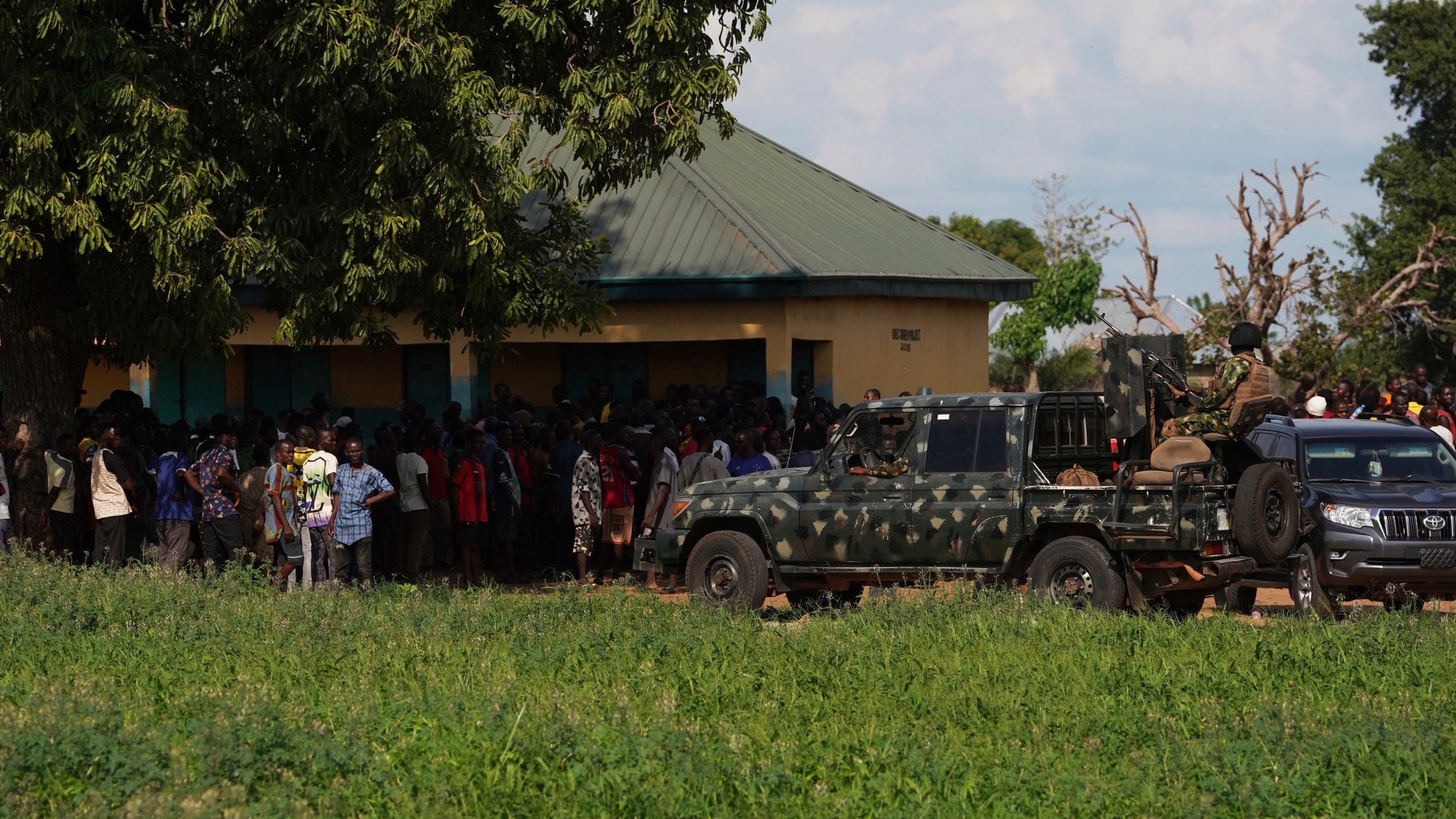 Soldiers stand guard prior to a visit from government officials following an attack by gunmen in Yelewata community north-central Nigeria, Monday, June 16, 2025. (AP Photo)