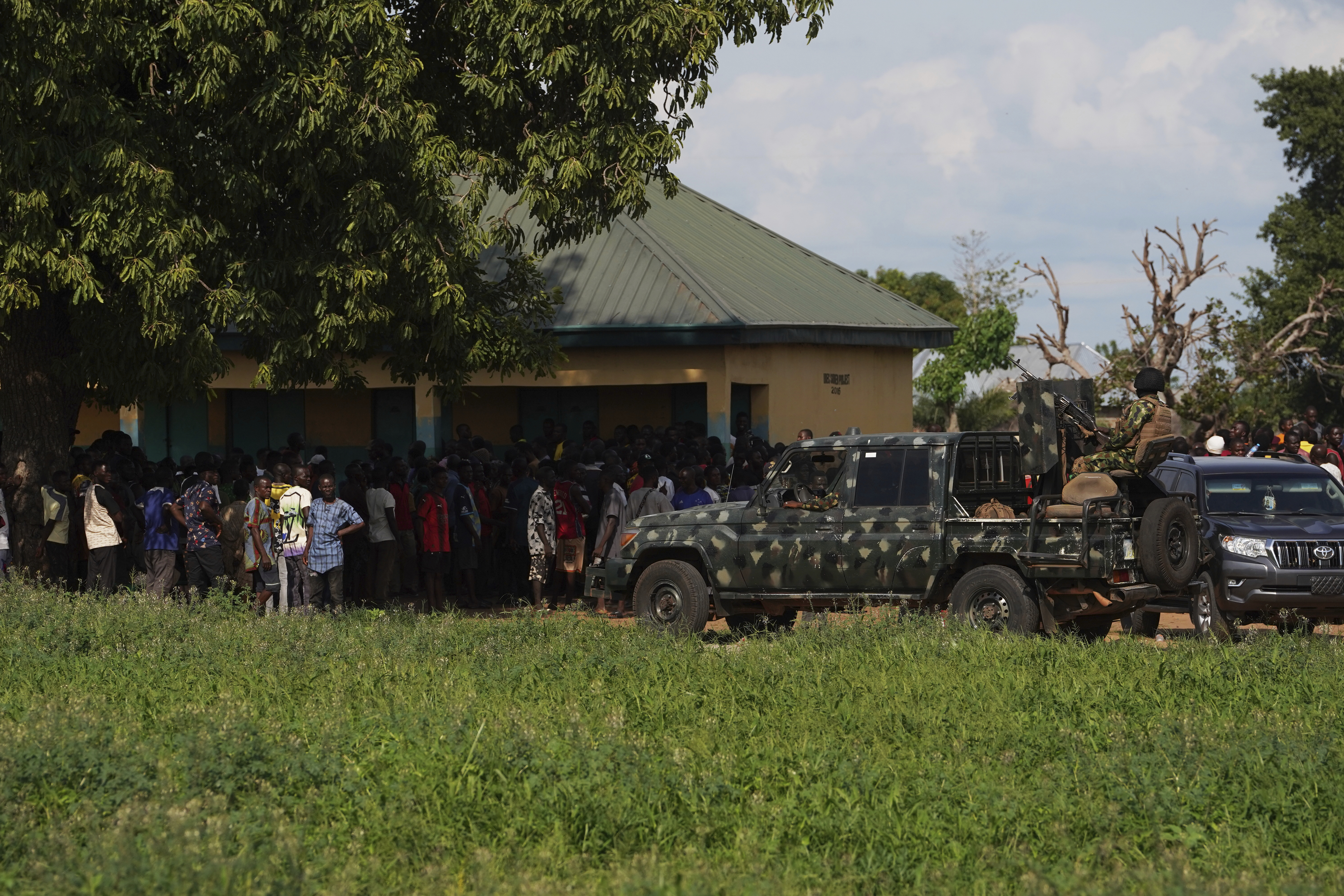 Soldiers stand guard prior to a visit from government officials following an attack by gunmen in Yelewata community north-central Nigeria, Monday, June 16, 2025. (AP Photo)