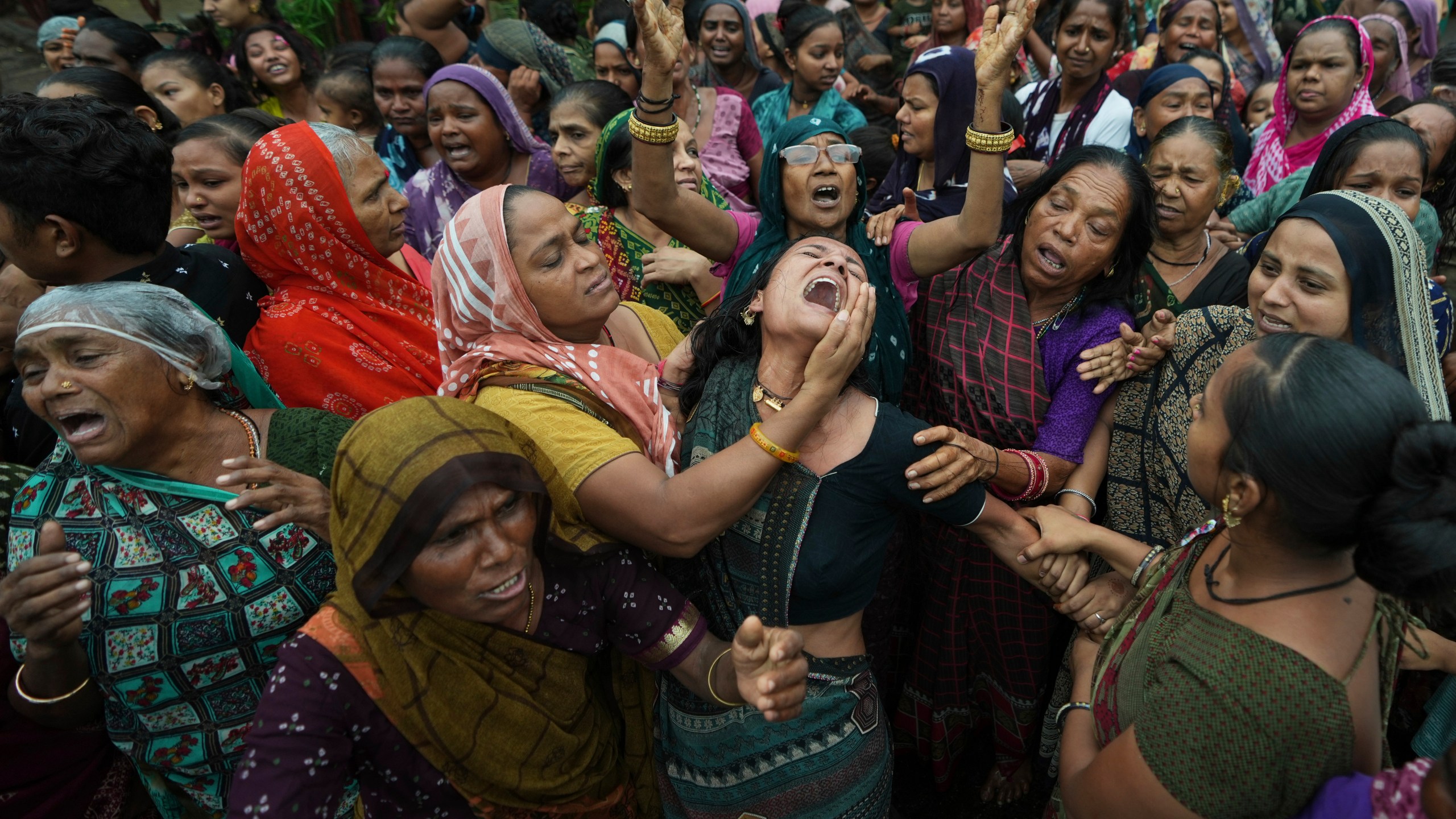 Family members and relatives of Akash Patni, victim of the Air India plane crash, grieve during his funeral procession in Ahmedabad, India, Tuesday, June 17, 2025. (AP Photo/Ajit Solanki)