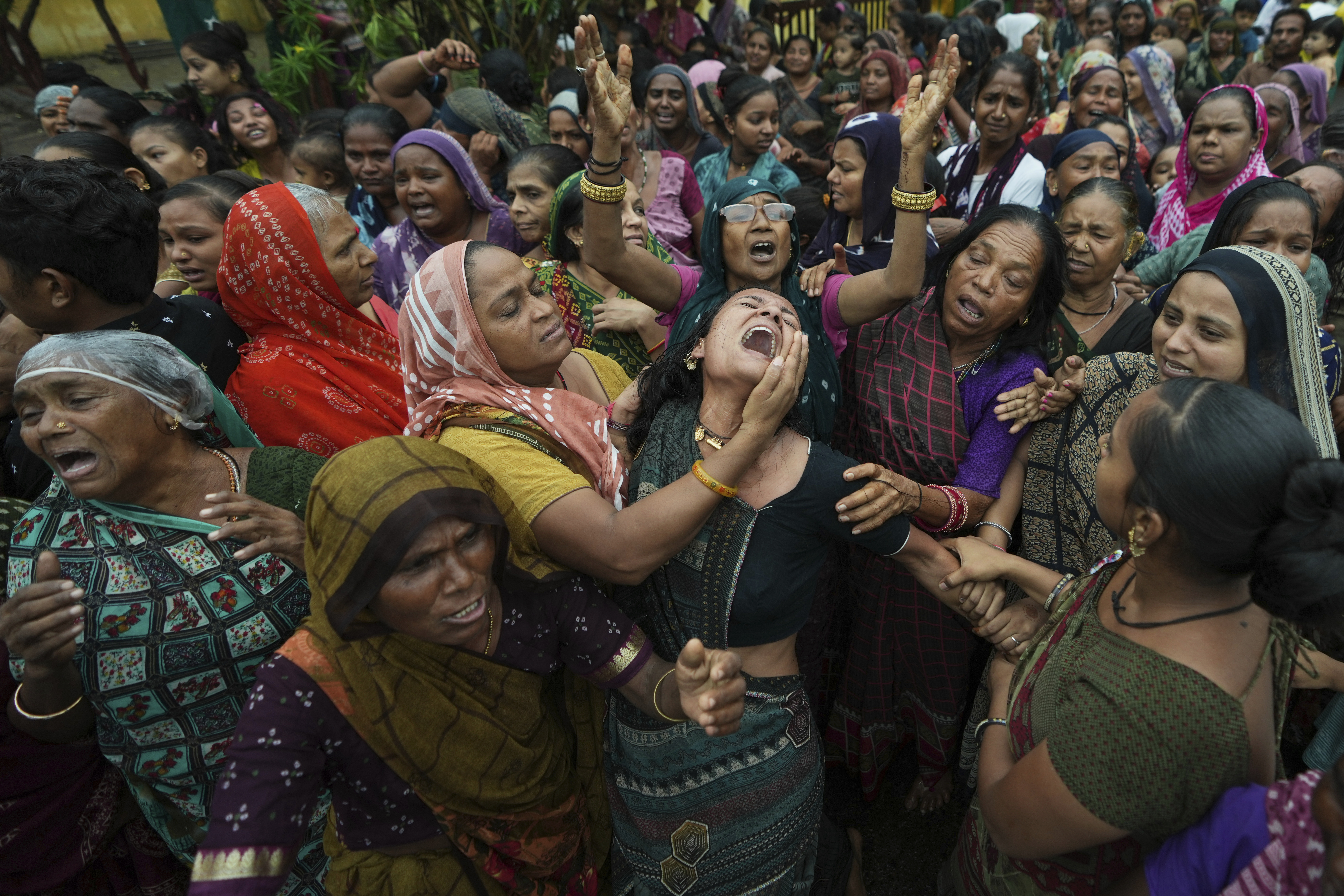 Family members and relatives of Akash Patni, victim of the Air India plane crash, grieve during his funeral procession in Ahmedabad, India, Tuesday, June 17, 2025. (AP Photo/Ajit Solanki)
