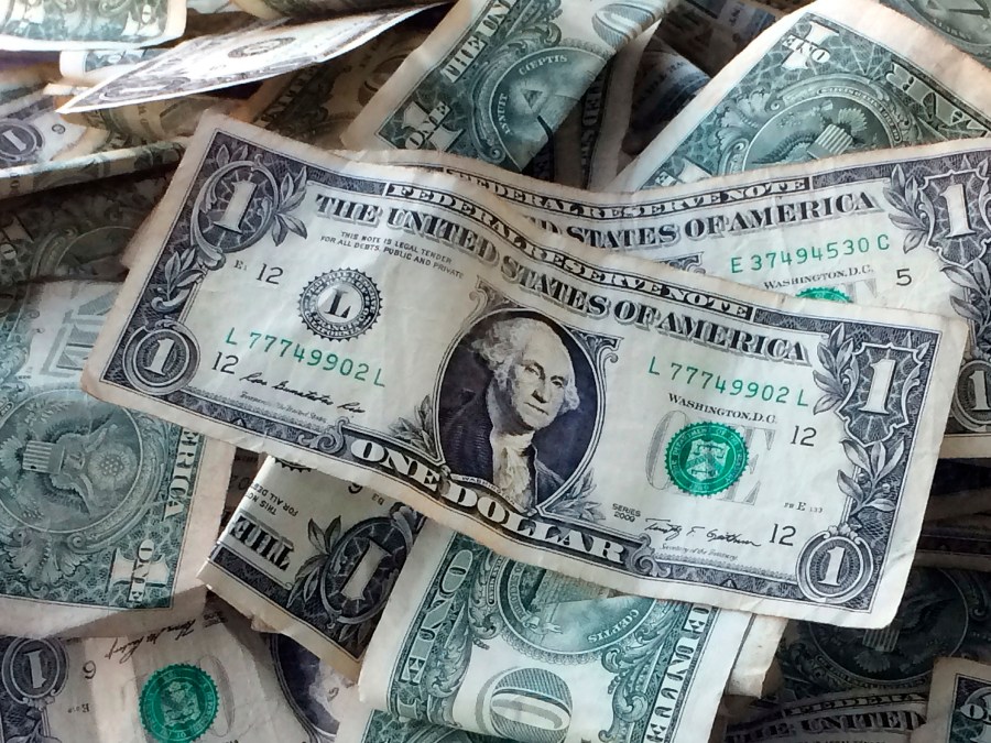 FILE - This Oct. 24, 2016 file photo shows dollar bills in New York. (AP Photo/Mark Lennihan, File)