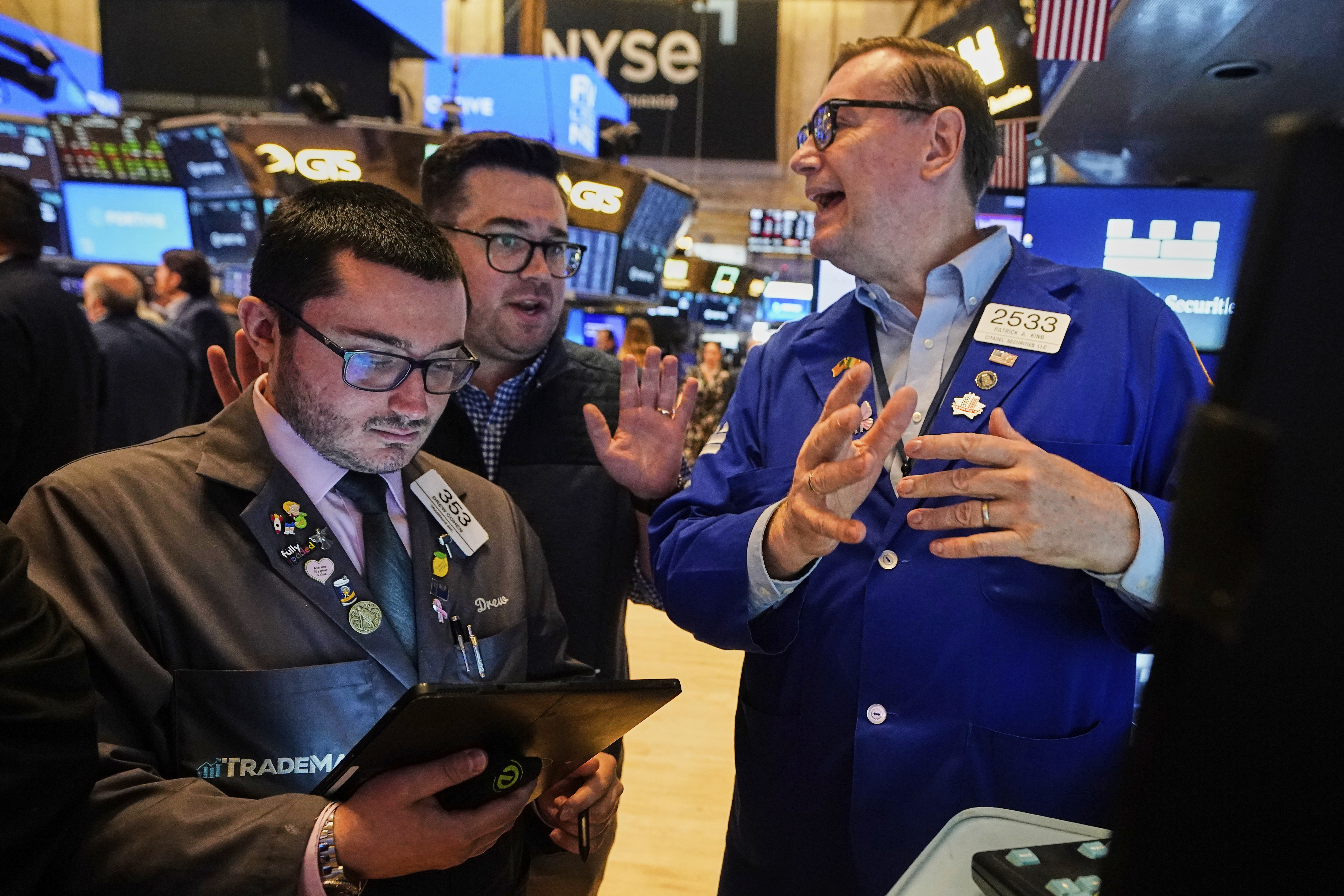 Traders Drew Cohen, left, and Joseph Lawler, center, work with specialist Patrick King on the floor of the New York Stock Exchange, Tuesday, June 10, 2025. (AP Photo/Richard Drew)