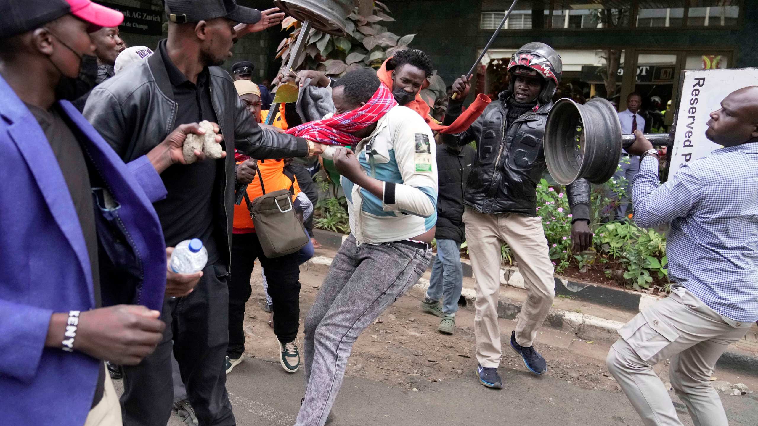 CORRECTS ACTION TO ATTACKED - A suspected pro government supporter is attacked by protesters during a demonstration over the death of blogger Albert Ojwang in police custody, in downtown Nairobi, Kenya, Tuesday, June 17, 2025. (AP Photo/Brian Inganga)