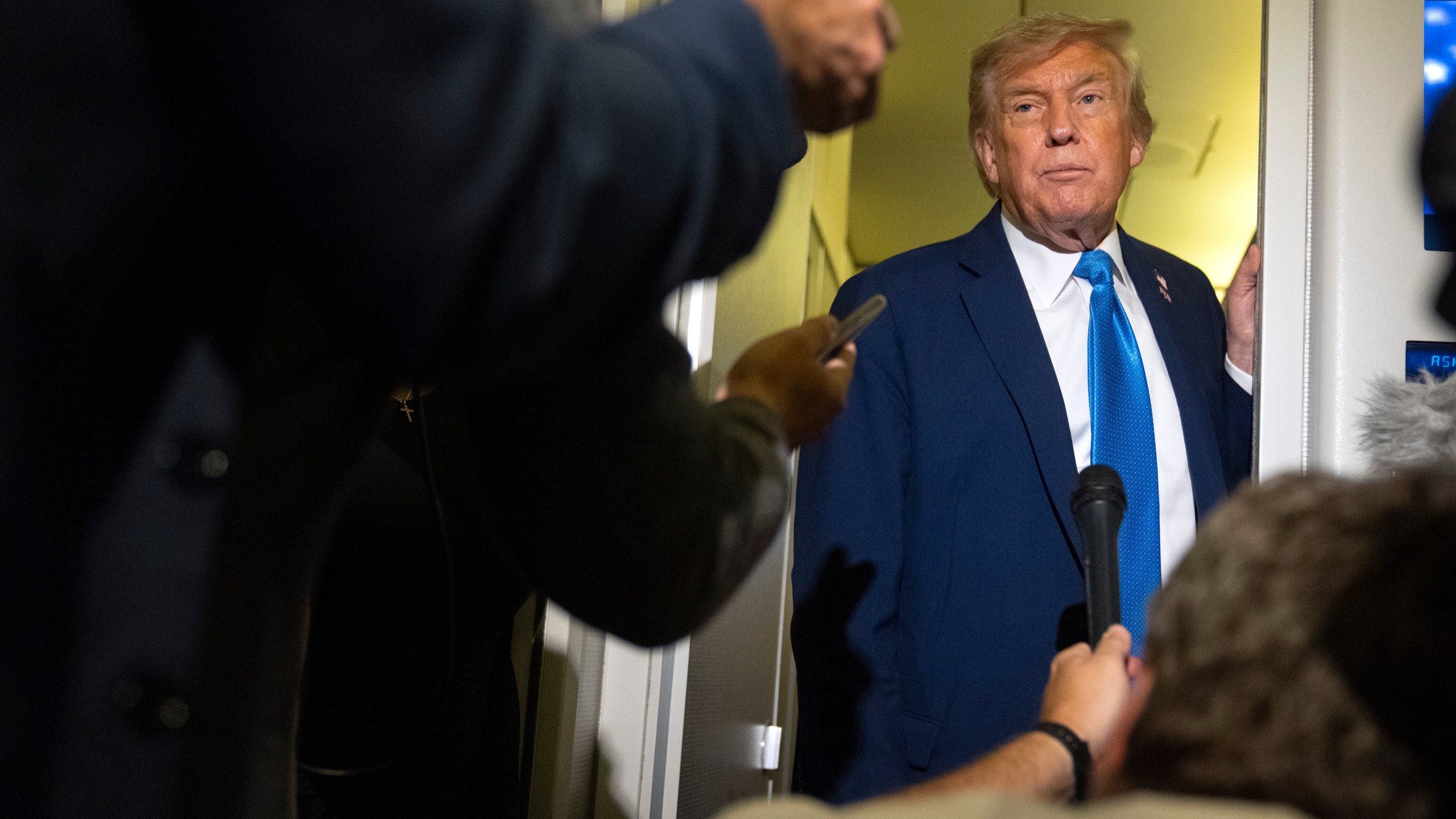President Donald Trump speaks with reporters while flying aboard Air Force One en route from Calgary, Canada to Joint Base Andrews, Md., late Monday, June 16, 2025. (AP Photo/Mark Schiefelbein)