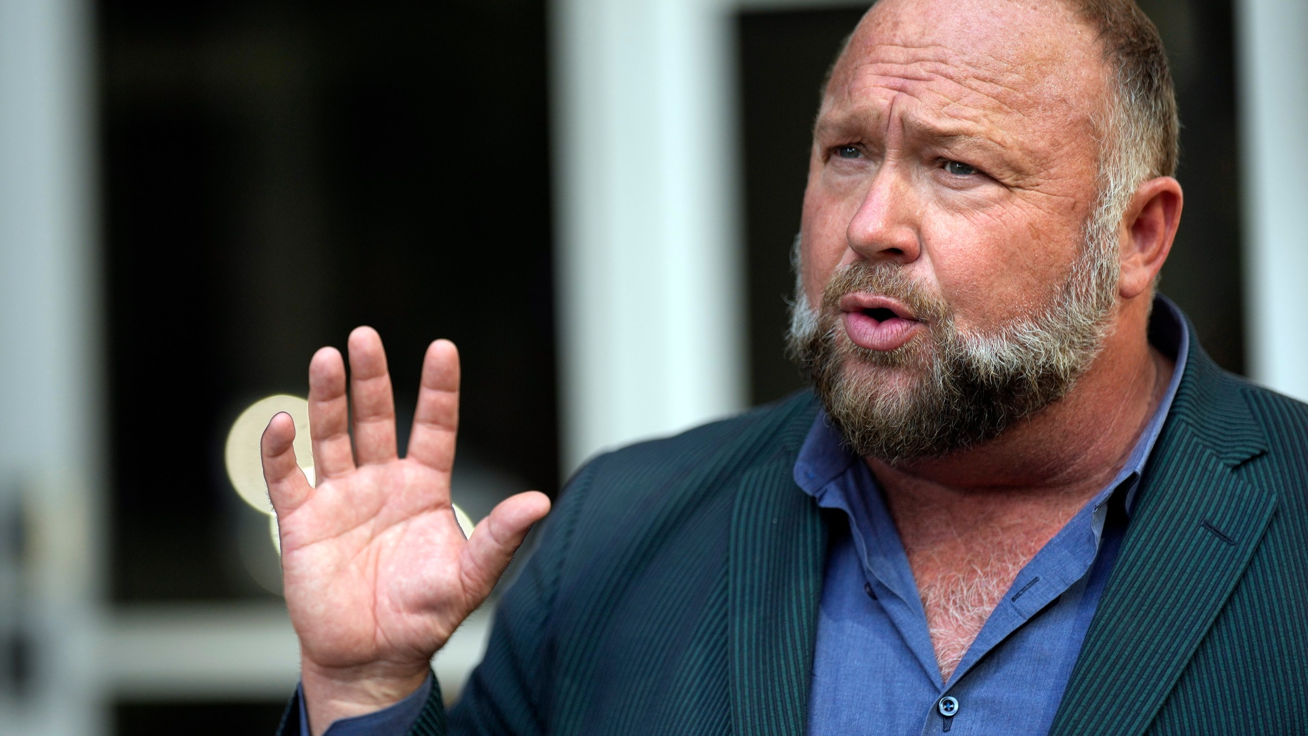 FILE - Right-wing conspiracy theorist Alex Jones speaks outside the federal courthouse after a bankruptcy hearing Friday, June 14, 2024, in Houston. (AP Photo/David J. Phillip, File)