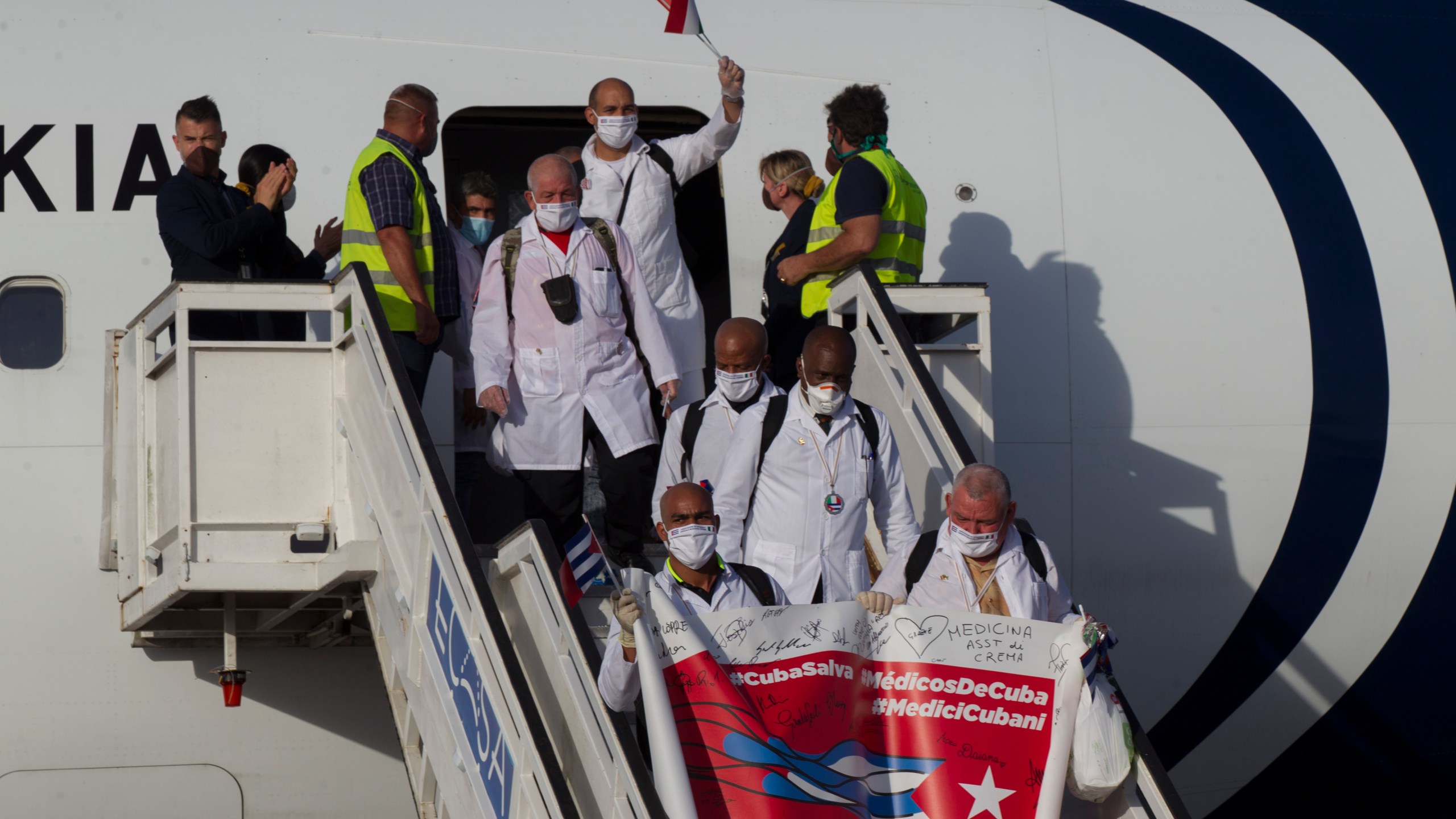FILE - Cuban doctors arrive at the Jose Marti International Airport in Havana, Cuba, June 8, 2020, after traveling to Italy to help with the COVID-19 emergency response. (Ismael Francisco/Pool via AP, File)