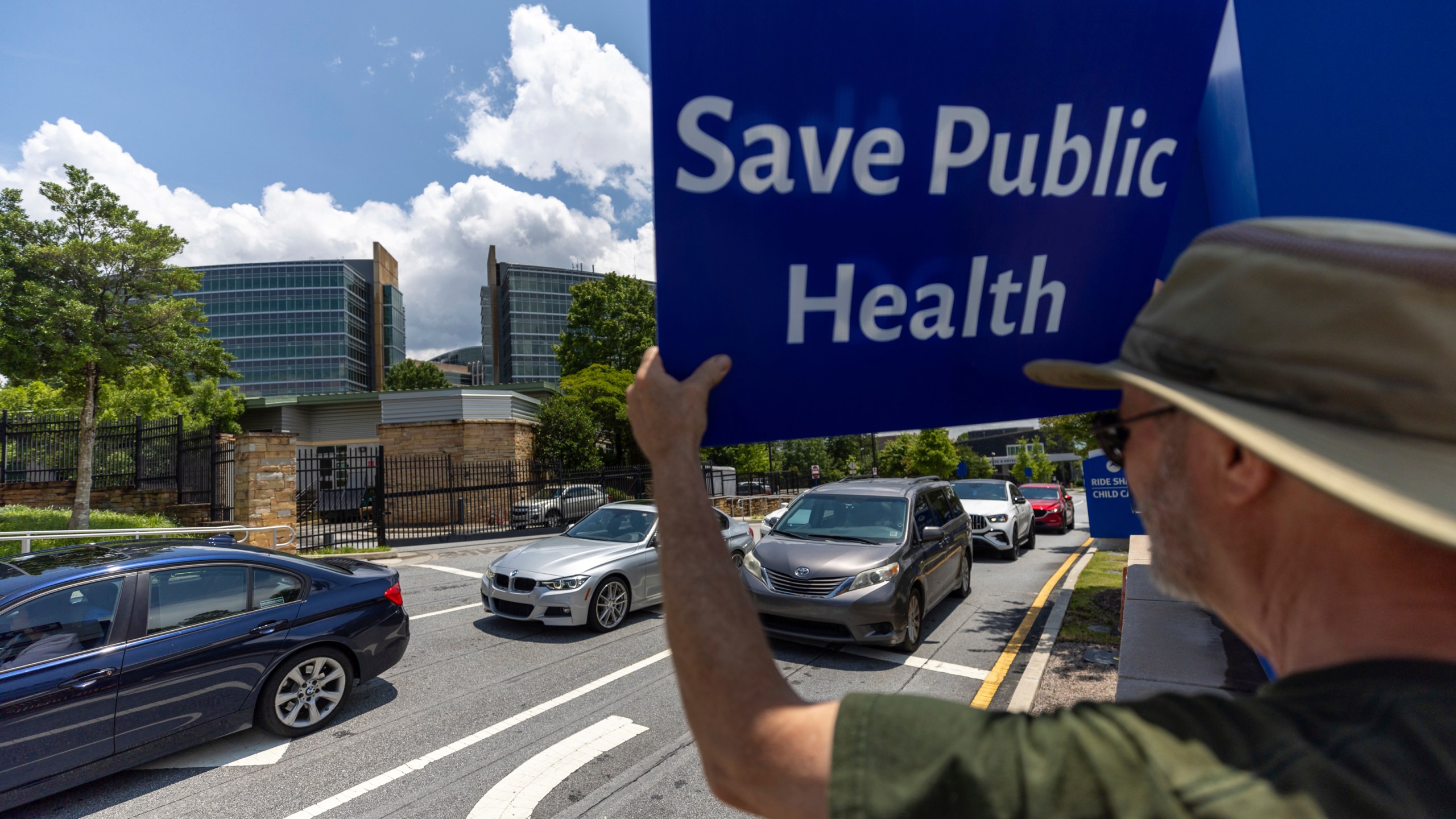 Michael Beach protests President Donald Trump's proposed cuts to health services outside the Centers for Disease Control and Prevention (CDC) headquarters in Atlanta on Tuesday, June 10, 2025. (Arvin Temkar/Atlanta Journal-Constitution via AP)