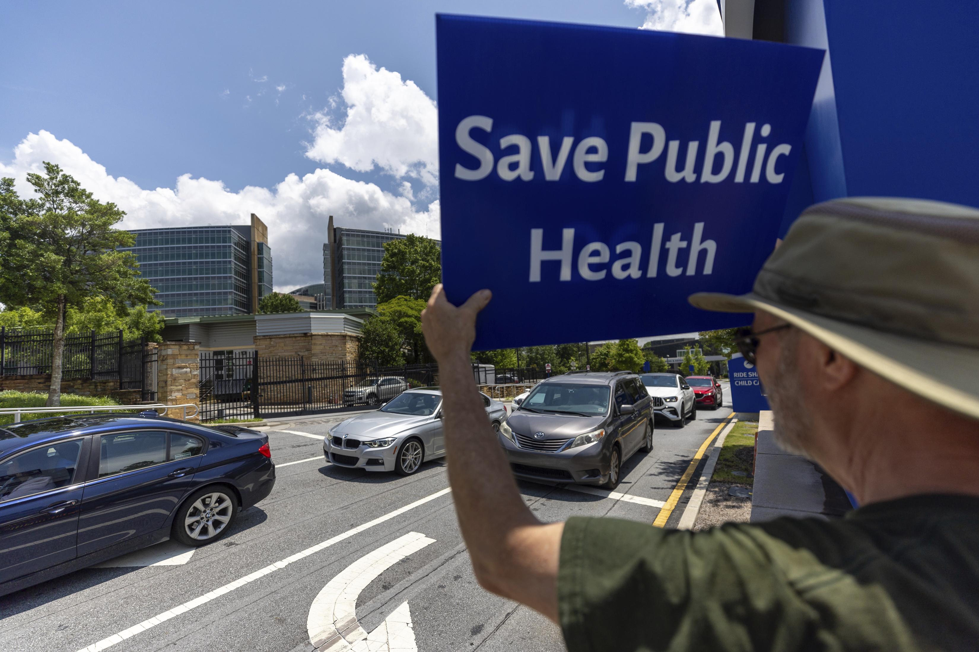 Michael Beach protests President Donald Trump's proposed cuts to health services outside the Centers for Disease Control and Prevention (CDC) headquarters in Atlanta on Tuesday, June 10, 2025. (Arvin Temkar/Atlanta Journal-Constitution via AP)