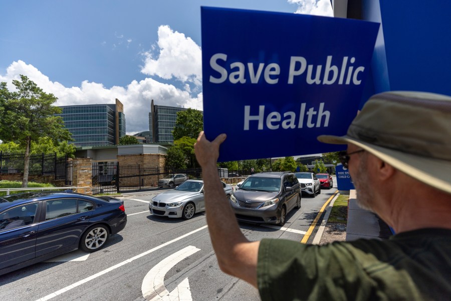 Michael Beach protests President Donald Trump's proposed cuts to health services outside the Centers for Disease Control and Prevention (CDC) headquarters in Atlanta on Tuesday, June 10, 2025. (Arvin Temkar/Atlanta Journal-Constitution via AP)