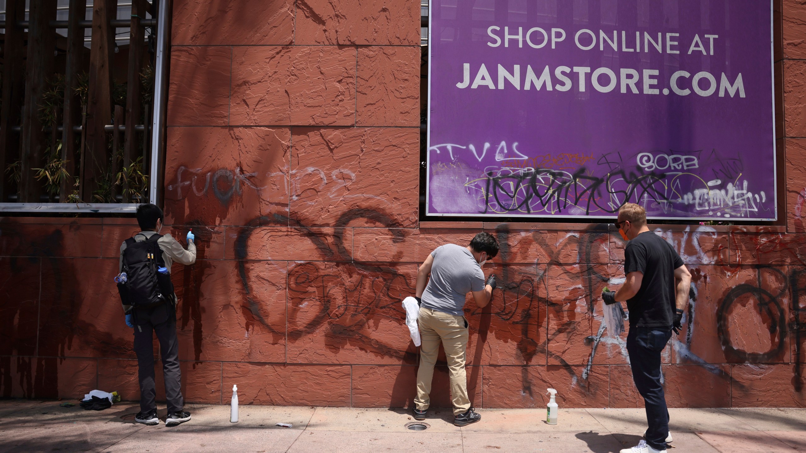 FILE - Volunteers remove graffiti from the the Japanese American Museum, Thursday, June 12, 2025, in downtown Los Angeles. (AP Photo/Etienne Laurent, File)