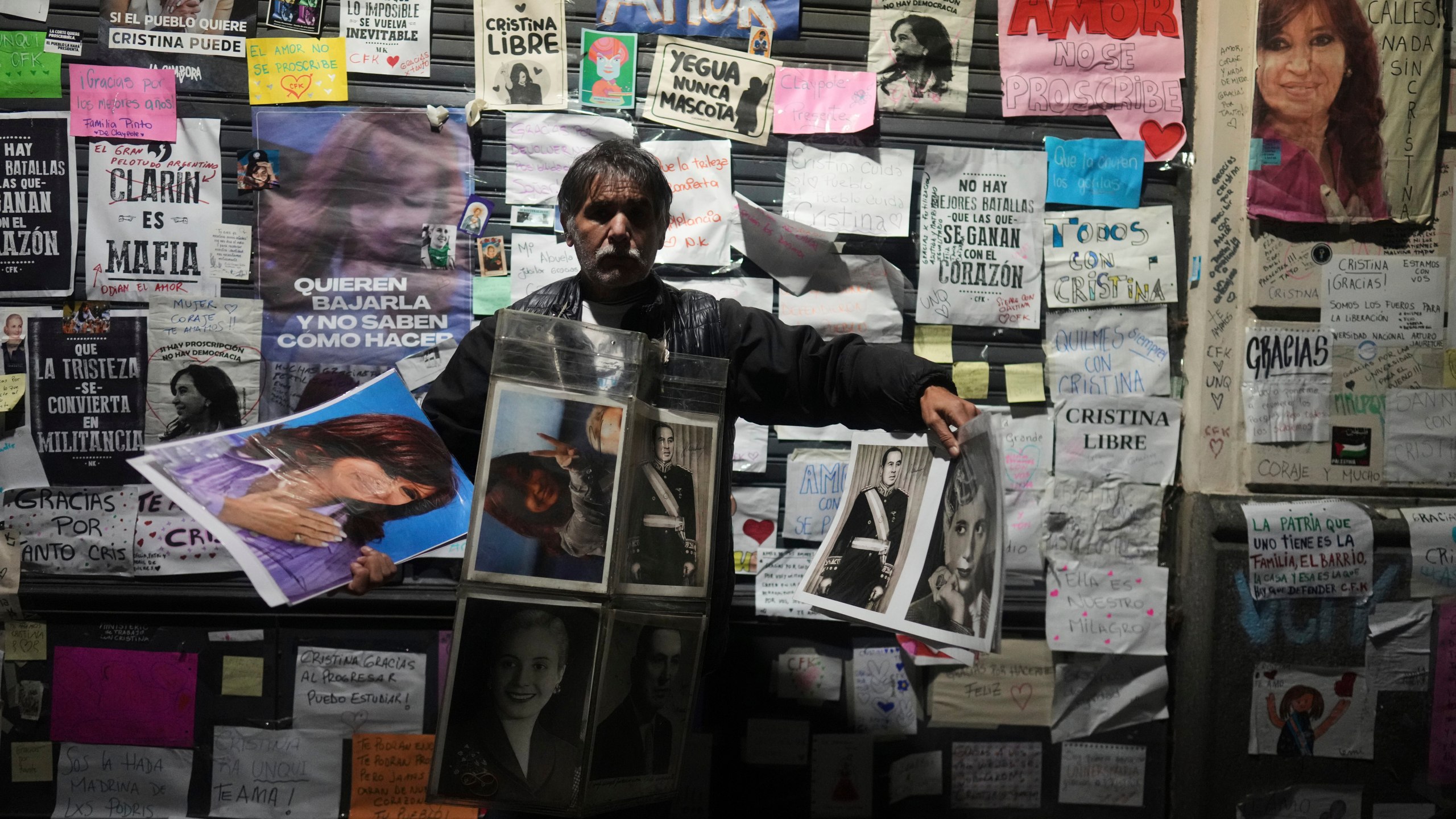 A vendor hawks pictures of former President Cristina Fernandez outside her home, after a federal court granted her request to serve a six-year prison sentence for corruption at her home, in Buenos Aires, Argentina, Tuesday, June 17, 2025. (AP Photo/Natacha Pisarenko)